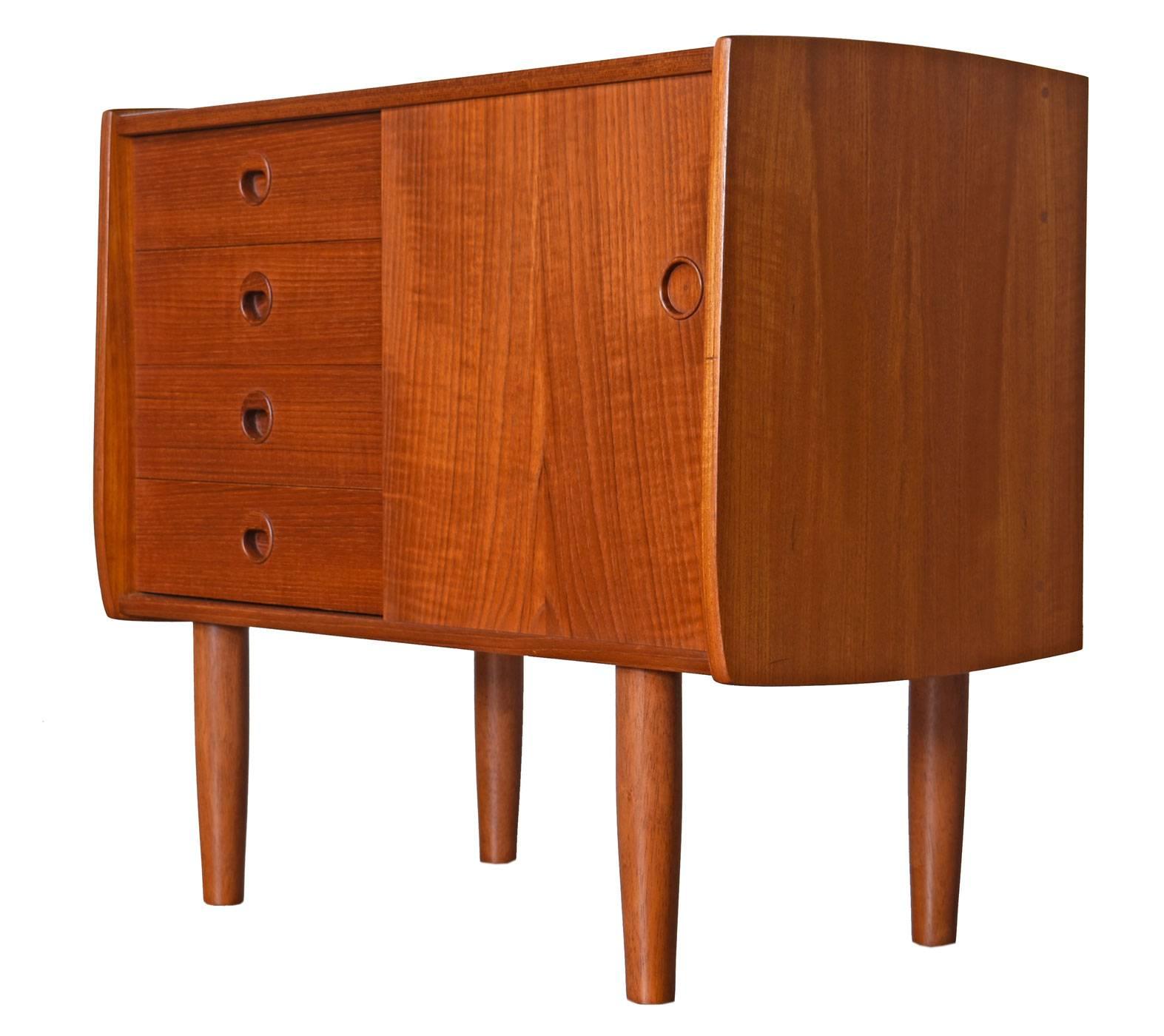 Pair of Danish modern teak oversized nightstands from the early 1960s. This rare find has had one owner up to now, has seen little use and has virtually been frozen in time. The pair are slightly different; one is a chest of three larger drawers,