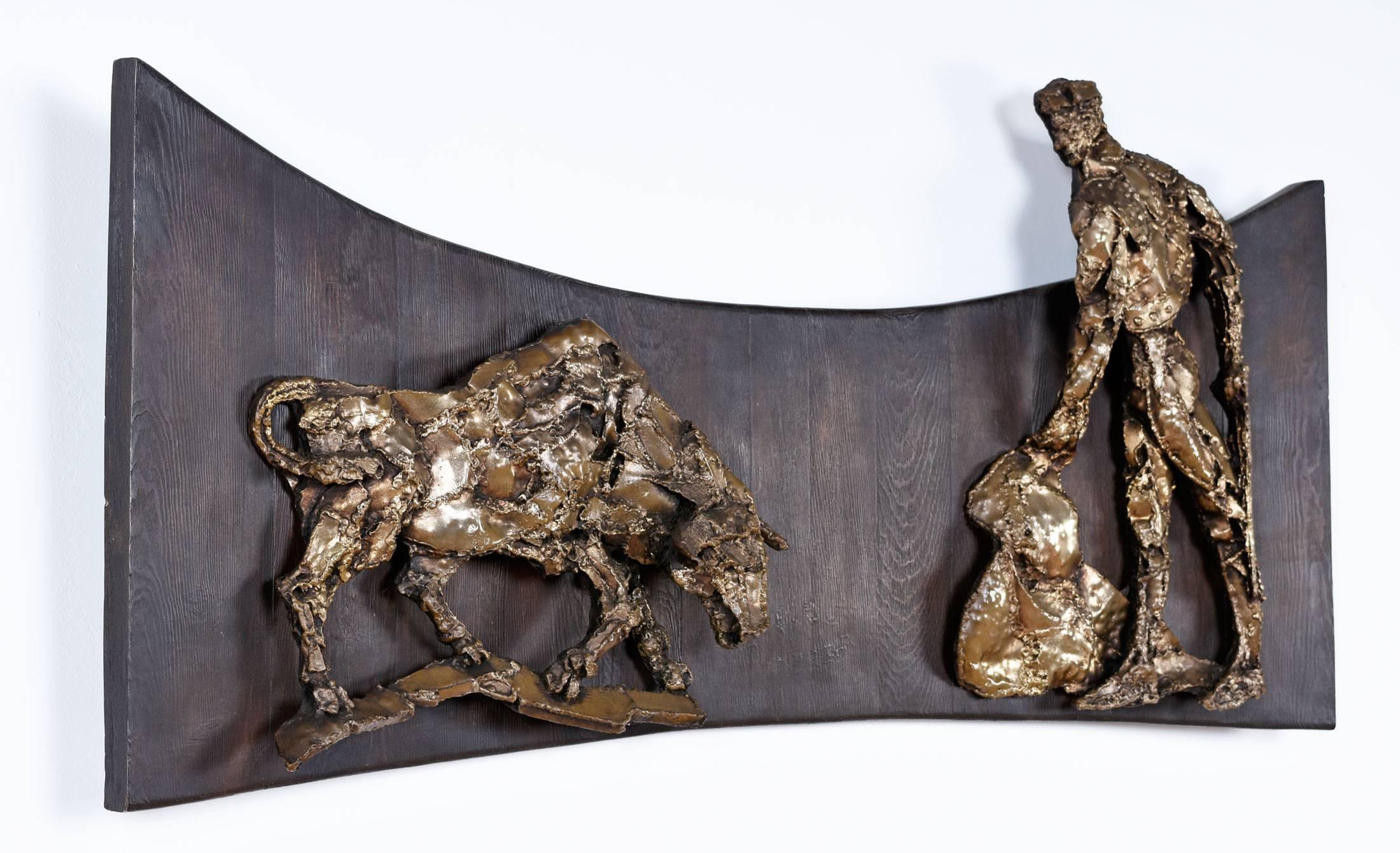 Impressive 5ft x 29.5" three-dimensional wall hanging Brutalist sculpture by Finesse Originals. The matador and bull are constructed of fiberglass made to give the effect of a bronze sculpture. The fiberglass figures are mounted on 1"