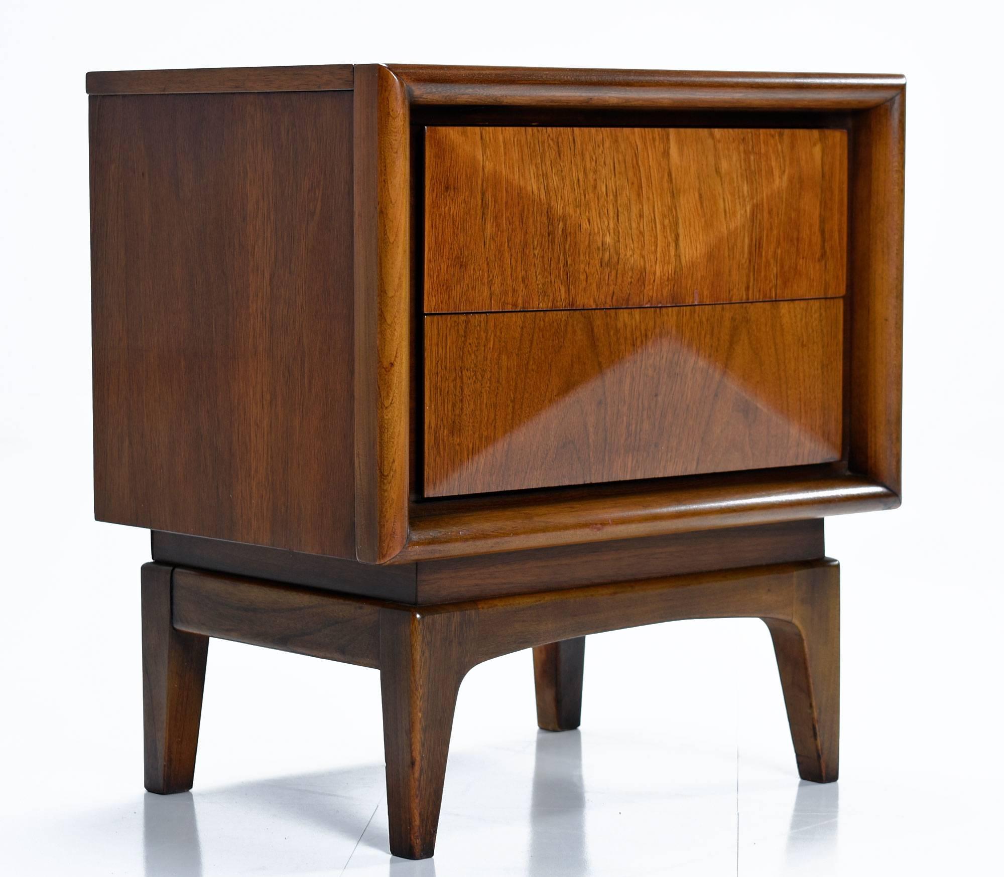 Mid-Century Modern United Furniture Company vintage, circa 1960s two-drawer matching nightstands. Danish style profile with expert, durable, American craftsmanship. Walnut wood veneer over solid wood. The drawers all feature. 5″ thick wood facades