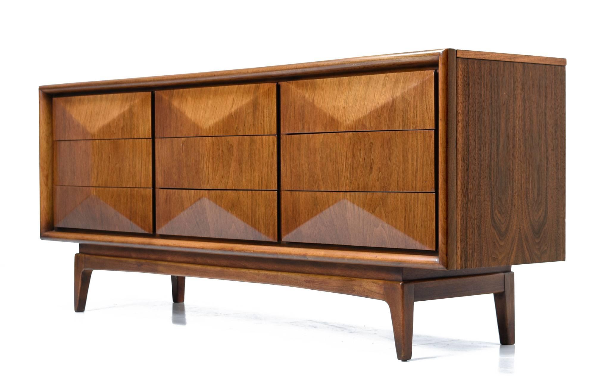 Mid-Century Modern United Furniture Company vintage circa 1950s nine-drawer triple dresser would work well in the bedroom as originally intended or in the living room re-purposed as an entertainment console. The long, Danish style profile