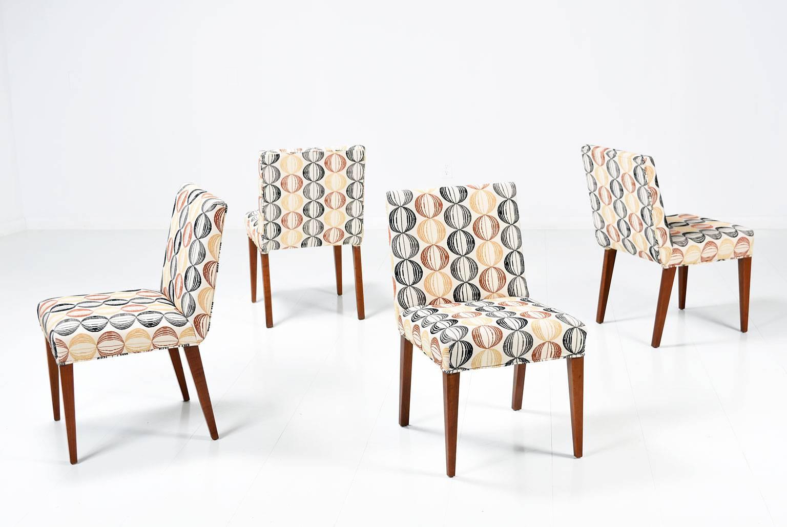 Set of 4 Mid-Century Modern Widdicomb slipper chairs, #4082. This handsome set features four armless side chairs, with walnut legs. They have been recently recovered in a luxurious, fun and colorful fabric, making them a great addition to any room.