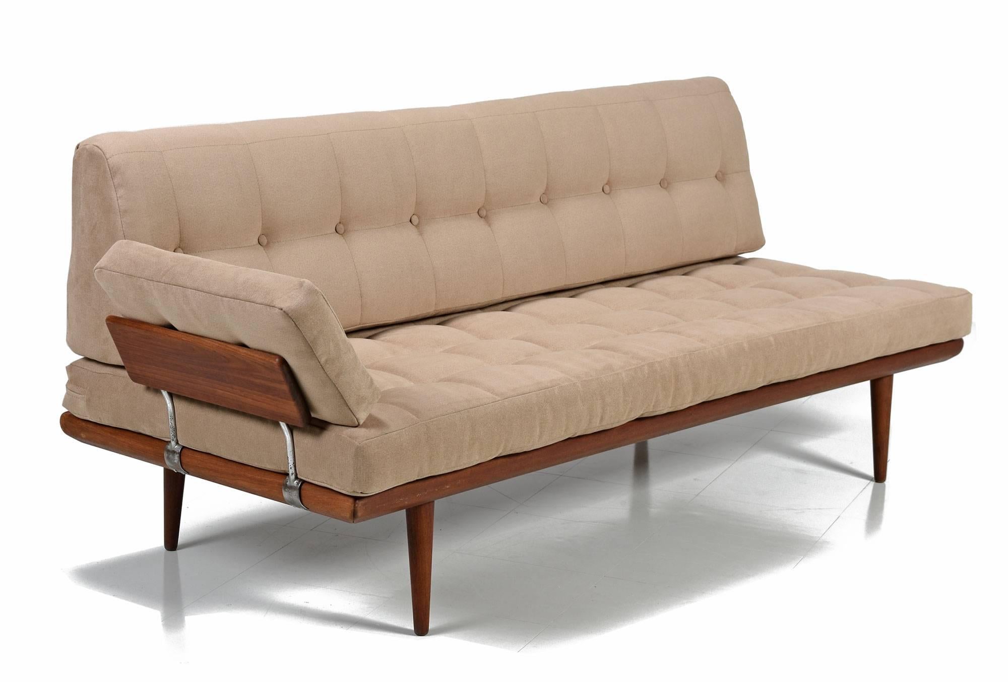 Handsomely restored Mid-Century Modern Minerva lounge sofas set designed by Peter Hvidt and Orla Mølgaard. This 20th century design gem features a loveseat and sofa daybed, each with a complementary arm rests, made of solid teak wood. Made for John