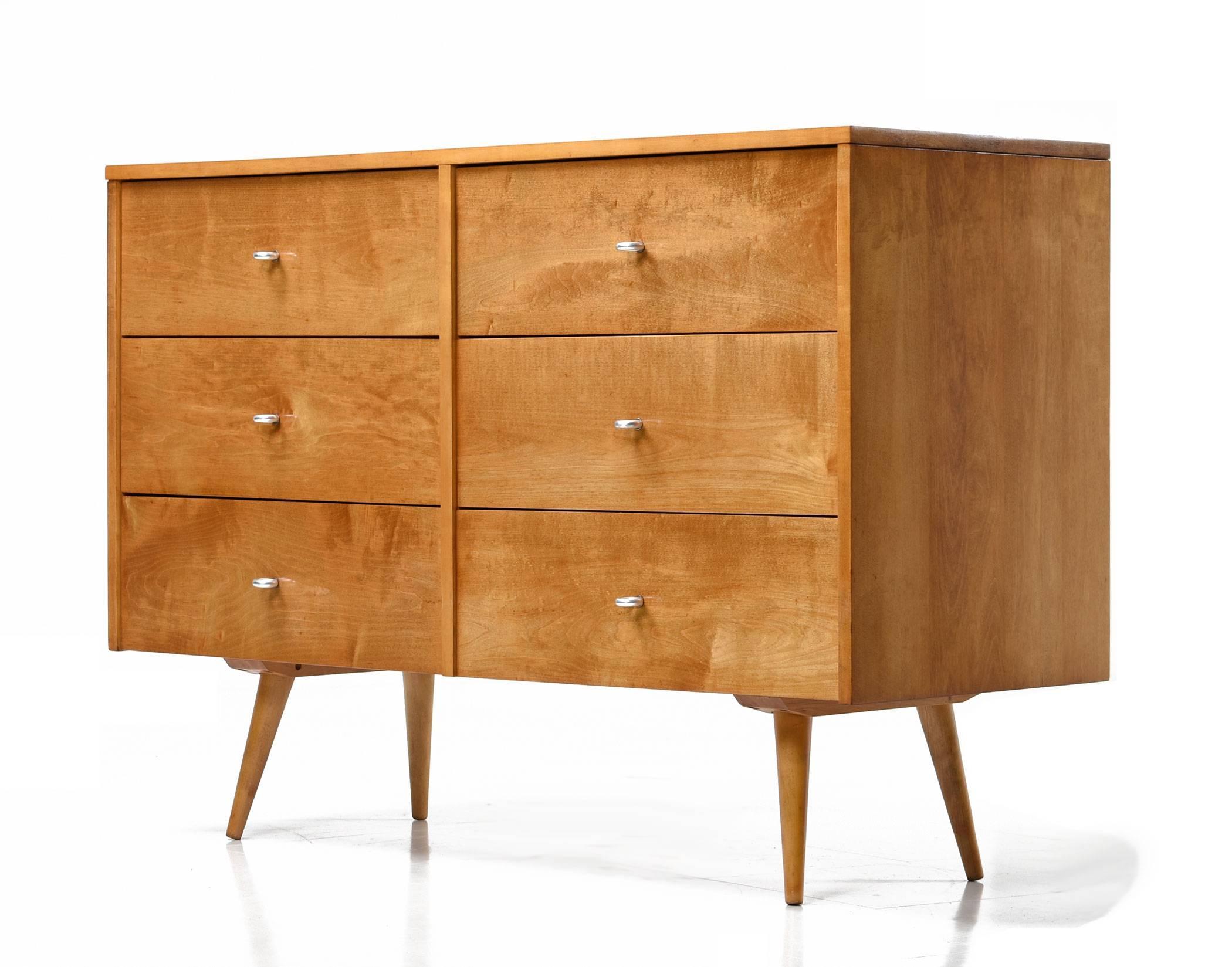 Mid-Century Modern dresser by Paul McCobb for Planner Group. This unit has been completely refinished. The six-drawer design is enhanced with loop shaped pulls. Solid wood construction, American made, Minimalist design accomplished by one of