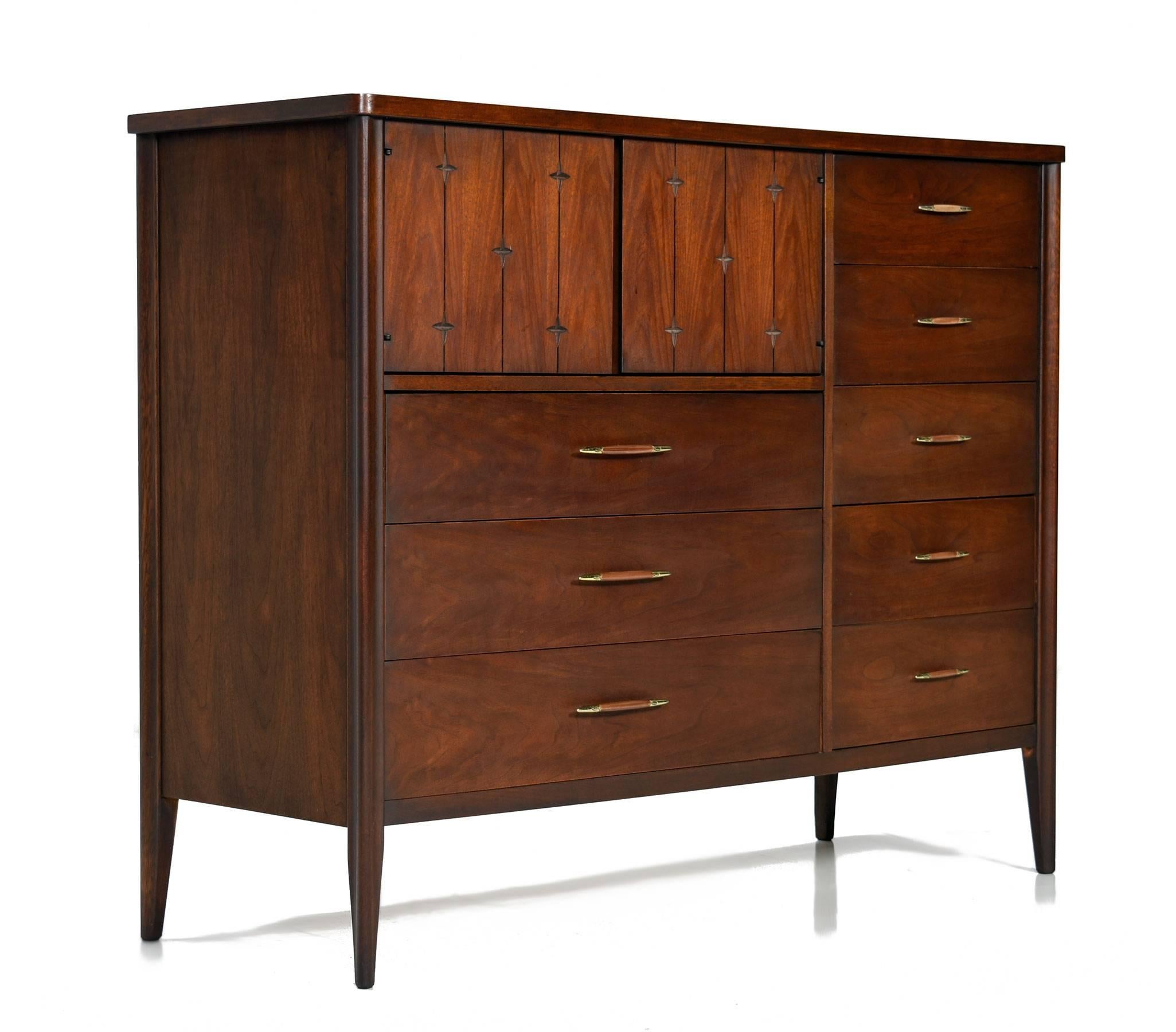 Mid-Century Modern Broyhill Saga magna dresser with both cabinet storage at top and eight drawers. The dresser is embellished with Saga's signature star motif, a hallmark design element of America's atomic age. This unit is a Titan when it comes to