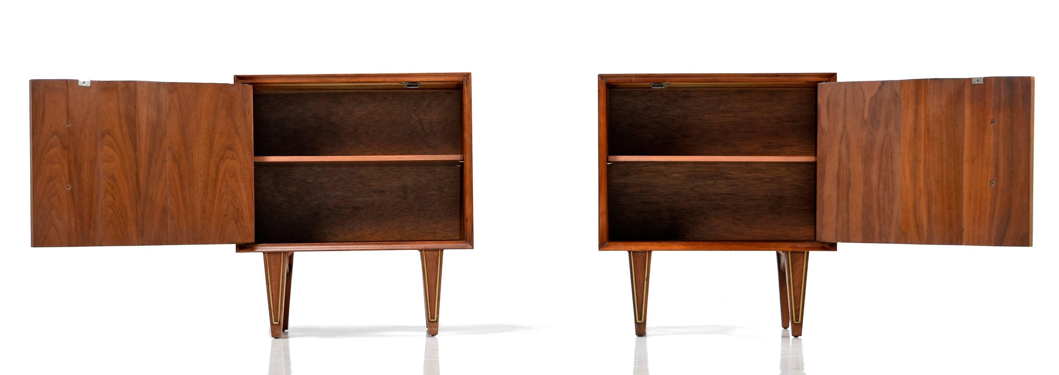 Stunning pair of Mid-Century Modern nightstands with diamond shaped pulls. This is a masterpiece of American 20th century design. Look at the pleated solid wood door and brass trimmed legs. There isn't a place on these nightstands that weren't
