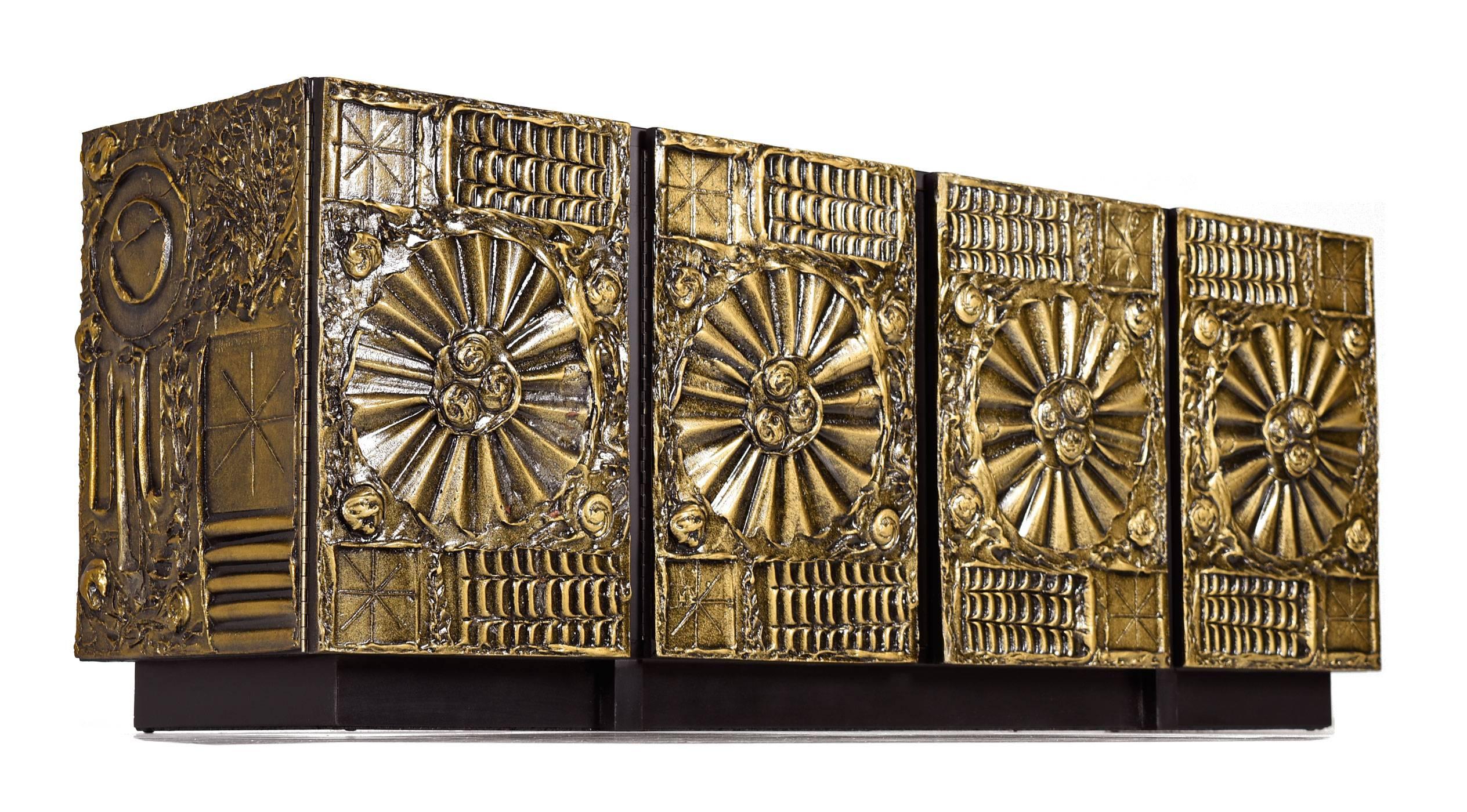 Impressive and rare Adrian Pearsall for Lane credenza. This large, four door credenza features resin carvings highlighted in gold in the style of Paul Evans. All four doors pop open to reveal large storage cabinets, the outside cabinets feature a