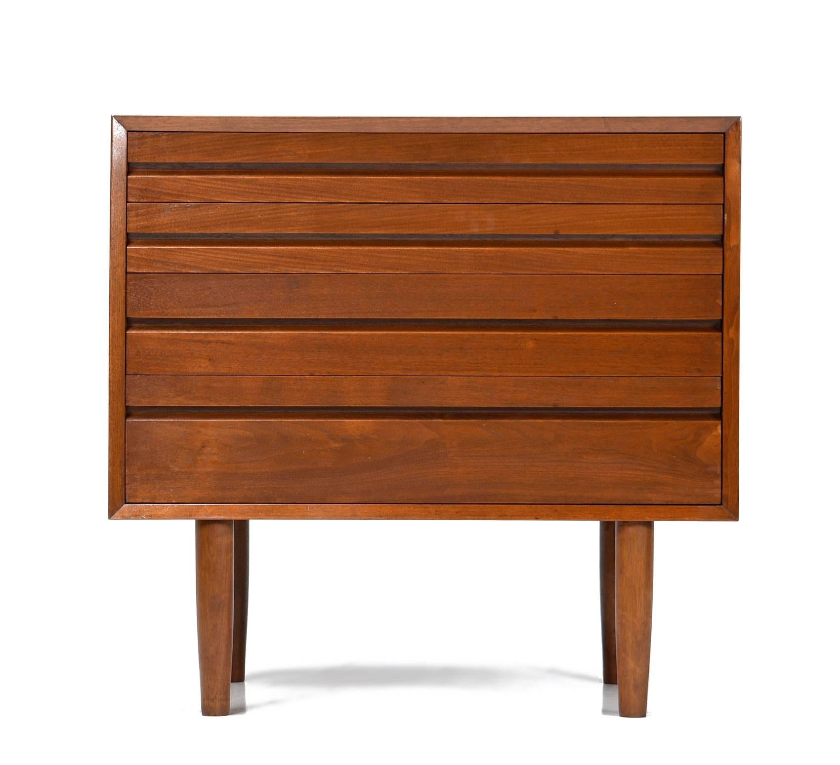 Sleek Danish modern designed four-drawer cabinet. Solid pine core construction with stunning walnut veneer and dovetail joinery.
