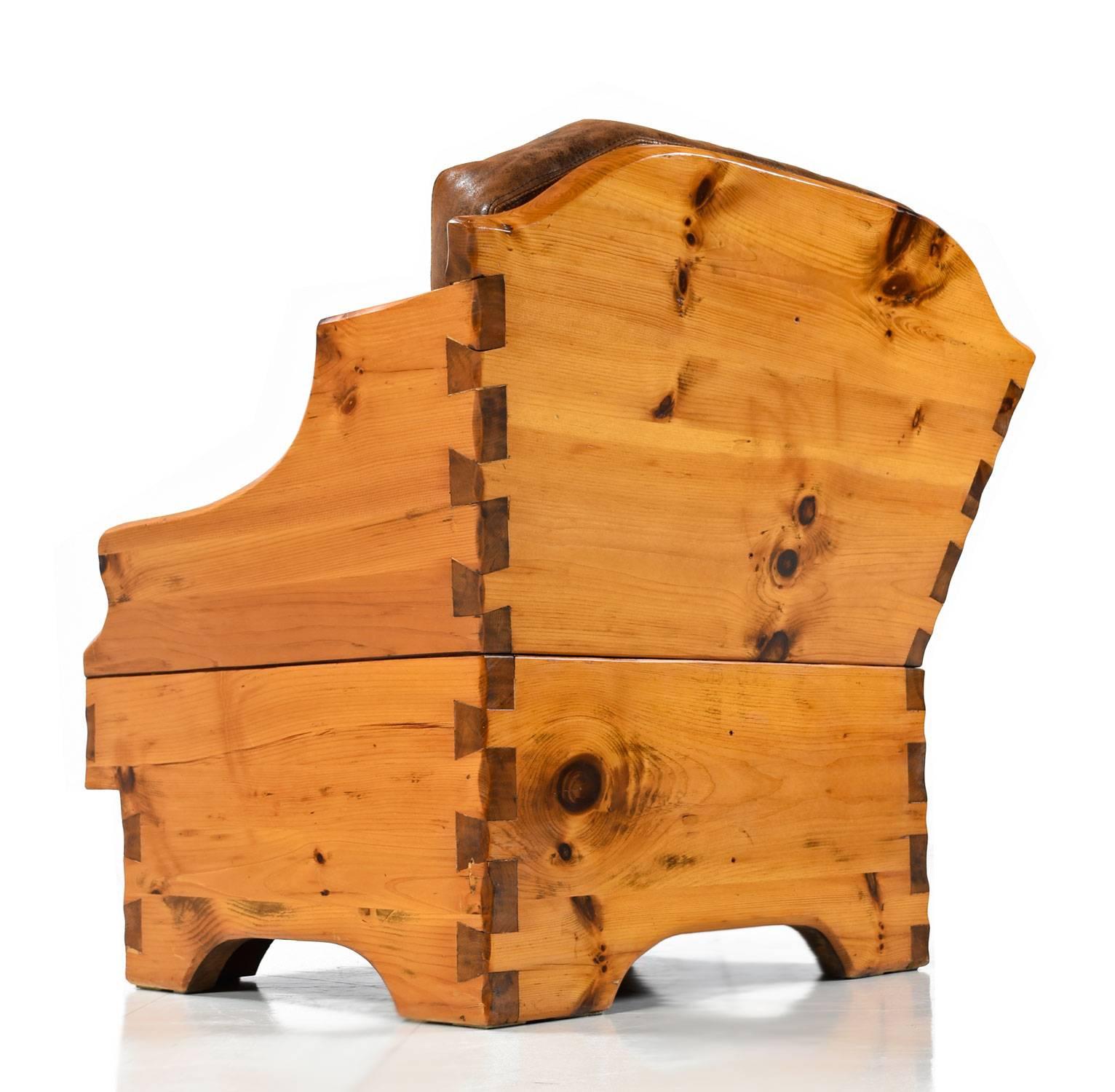 Restored solid pine handcrafted, one of a kind armchair. The masterful craftsmanship is left exposed as a design element. Large dovetail joints are a darker tone, enhancing their presence. The thick planks of knotty pine are sure to last many more