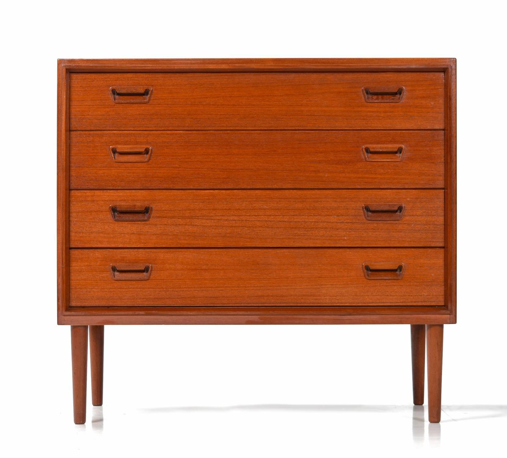 Stunning early Mid-Century Modern Danish teak chest by Munch Mobler. The vintage 1950s cabinets have a deep red hue patina to the over half-a-century old teak wood. The cabinet is exquisitely crafted with tight dovetail drawers and all wood