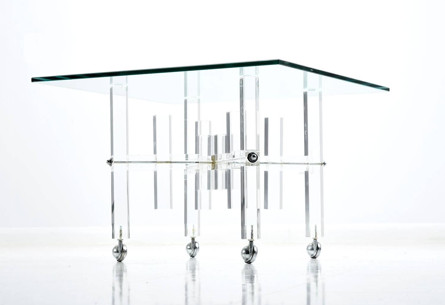 This vintage Lucite occasional table can be used as a coffee table or end table. In fact, in small spaces, it can double as both! Wheels beneath the table allow one to easily reposition the table. The staggered acrylic base is topped with elegant,