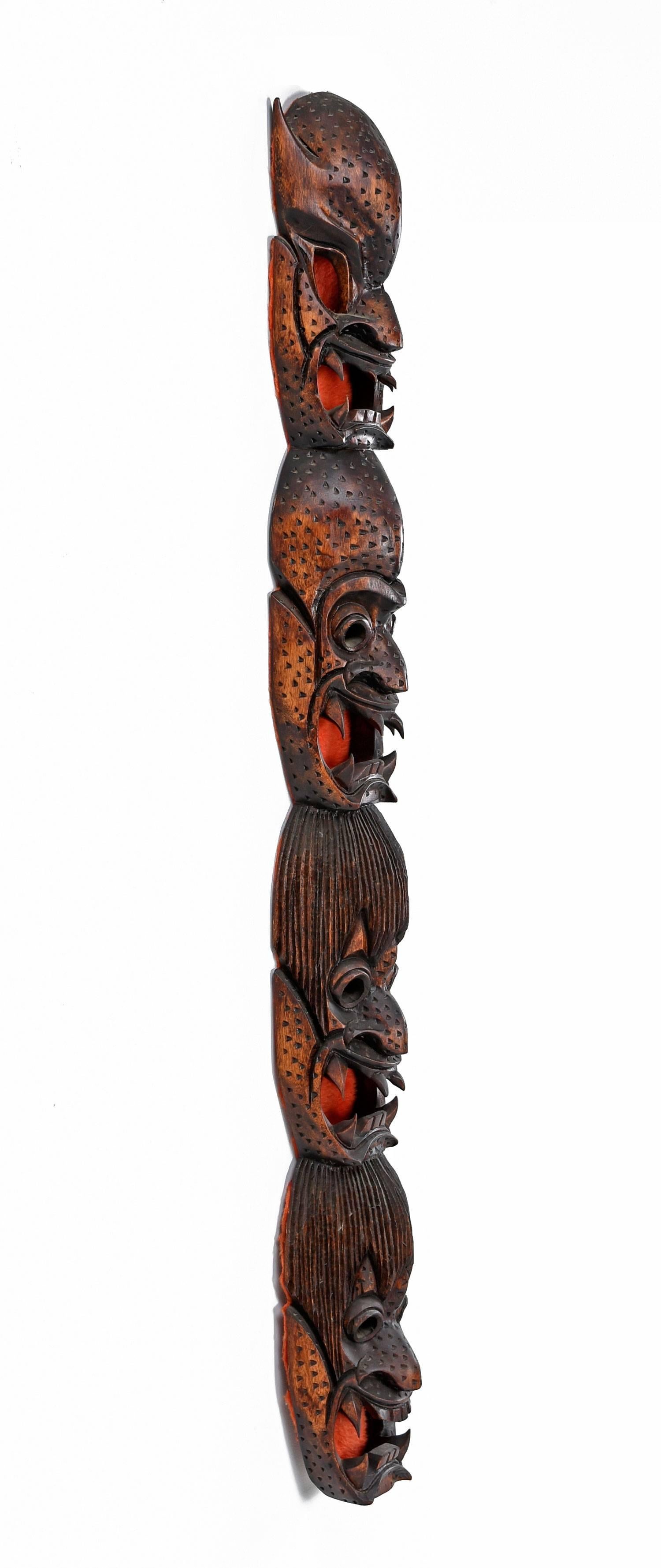 This Totum style wall hanging exhibits four stacked, devilish, demonic faces. Handmade by one of the Igorot Ifugao Bontoc tribes in Northern Philippines. Perhaps designed to represent wrathful gods. The pointed teeth are actually sharp. The masks