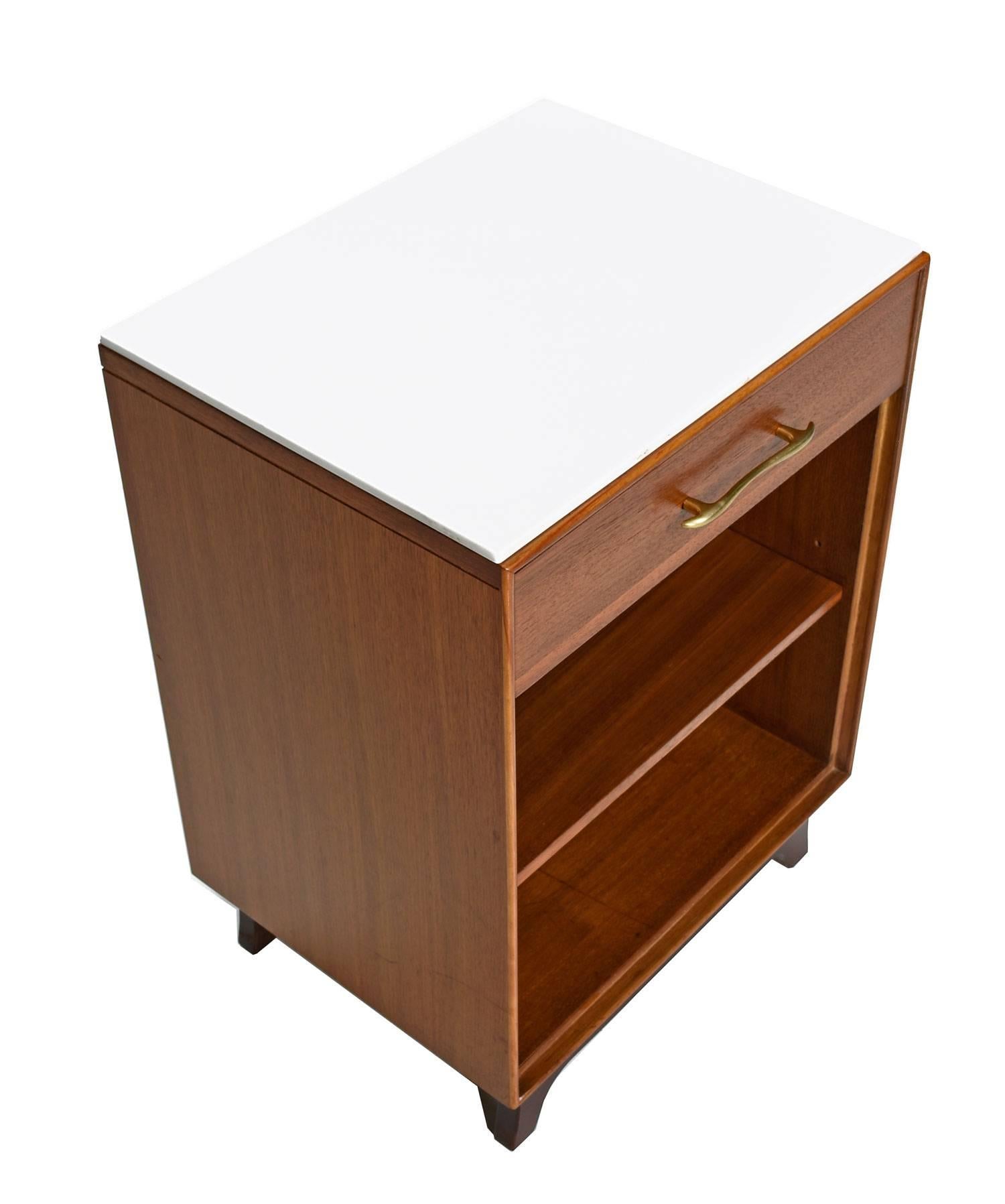 This Mid-Century Modern pair of nightstands by RWAY features expert craftsmanship and spectacular walnut wood. The nightstands comes with a piece of polished white stone to accent and protect the top surface. Place perfume bottles, drinks and