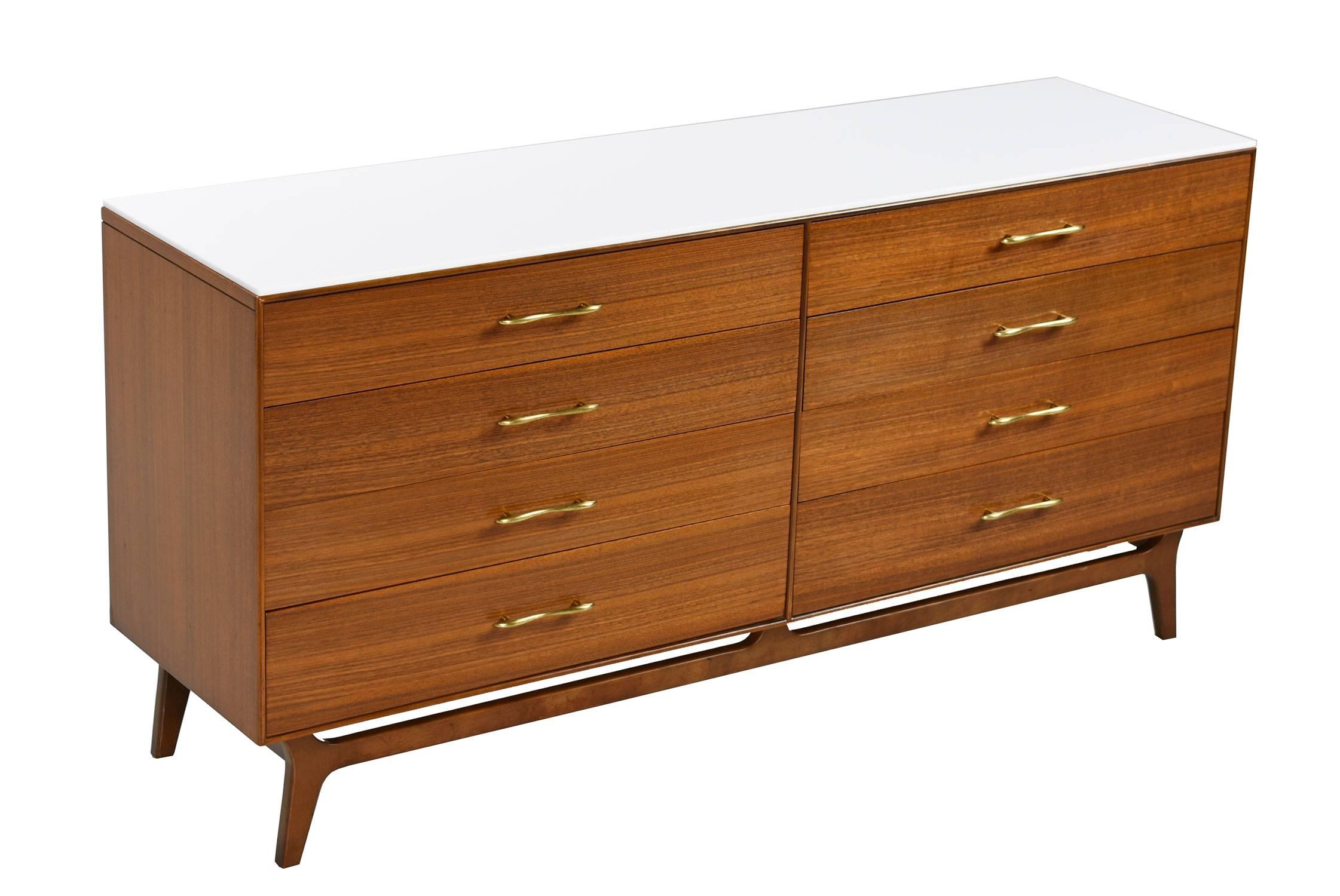 This Mid-Century Modern eight-drawer dresser by RWAY features expert craftsmanship and spectacular walnut wood. The dresser comes with a piece of polished white stone to accent and protect the top surface. Place perfume bottles, drinks and