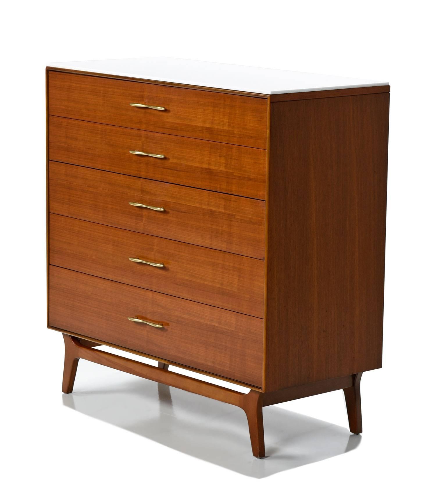 This Mid-Century Modern five-drawer dresser by Rway features expert craftsmanship and spectacular walnut wood. The dresser comes with a piece of polished white stone to accent and protect the top surface. Place perfume bottles, drinks and toiletries