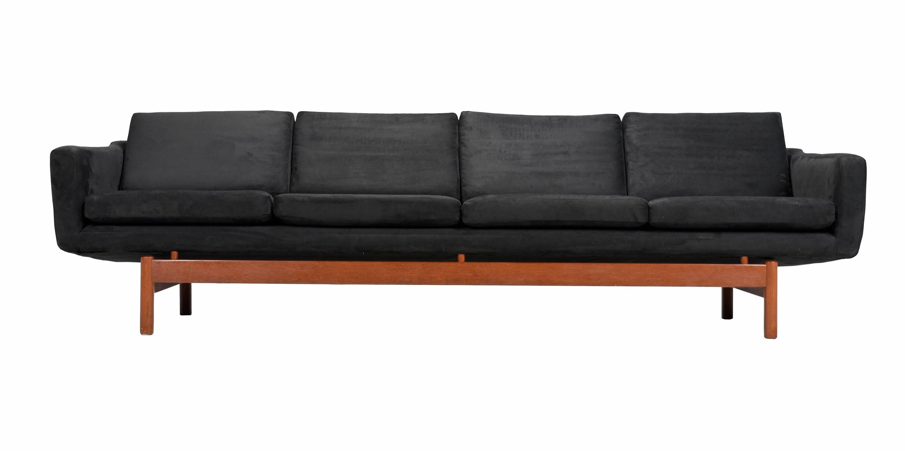 Early Mid-Century Modern Danish teak sofa with newer black upholstery. This sofa was recently recovered by the previous owner and has like-new condition upholstery. Besides the newer fabric covering, the sofa has been professionally steam cleaned to