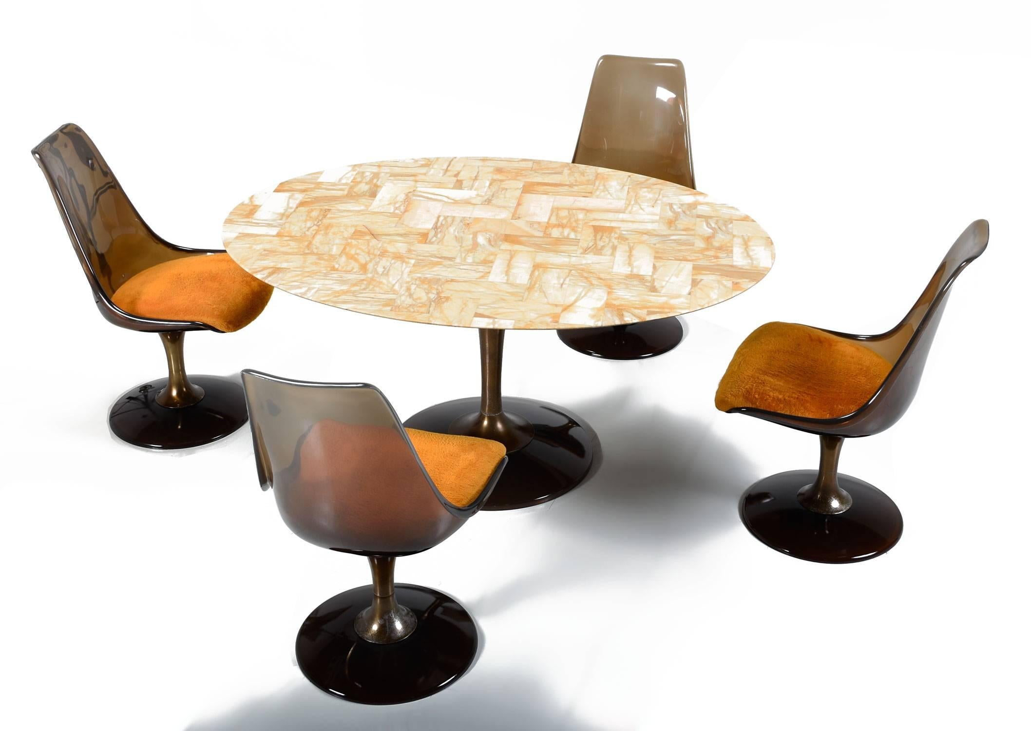 Super funky vintage 1970s, dining set by Chromcraft. The set comes with four Lucite chairs and oval dining table as pictured. The table is made of a resin that looks like a marbled stone. Each chair features the original fuzzy orange seat