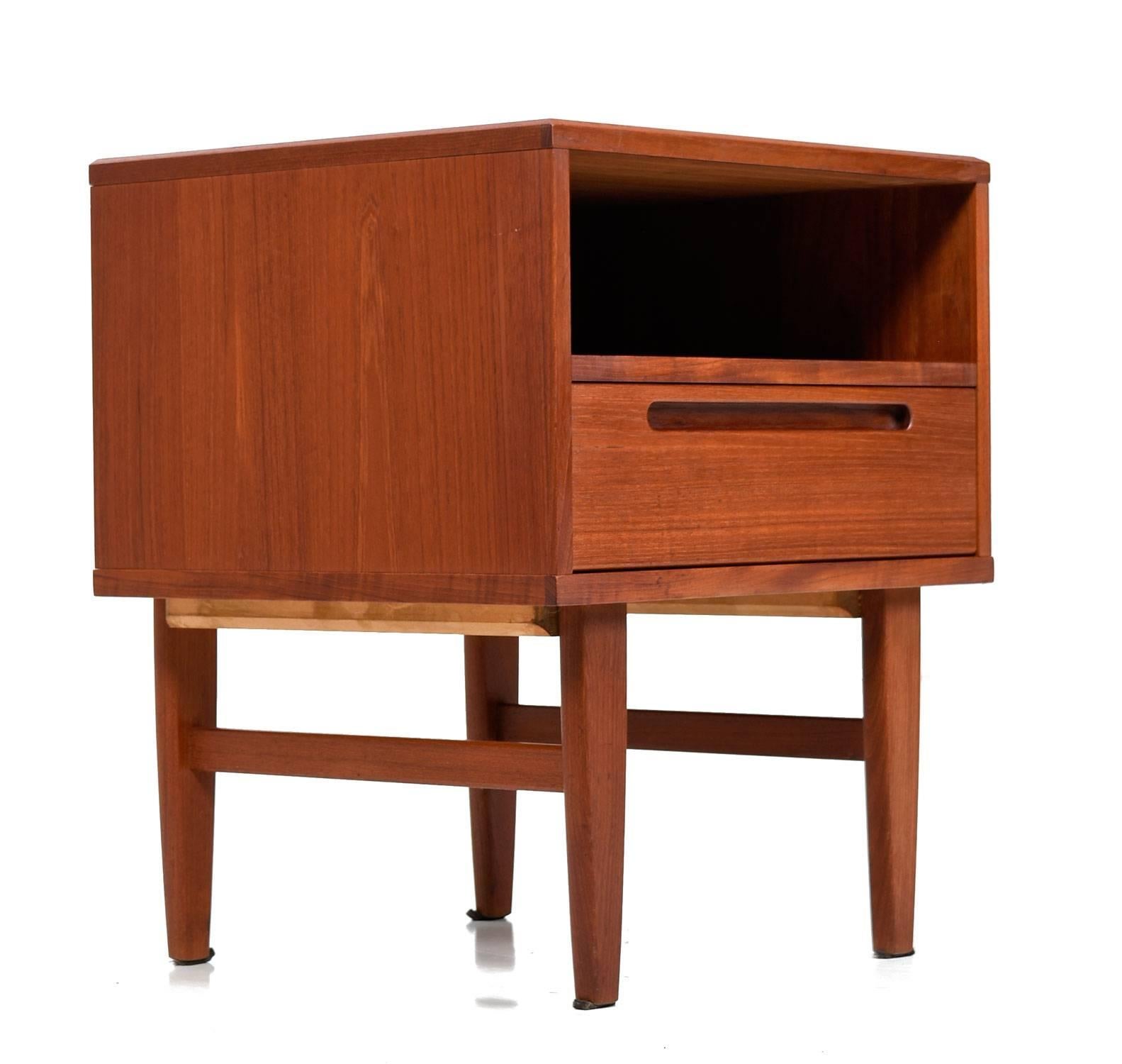 Expertly crafted Mid-Century Modern Danish teak nightstand by Nils Jönsson for HJN Møbler. This pieces is an exemplary specimen of Danish cabinet making. Tightly dovetailed drawers, no particle board, beautiful teak wood and easy gliding drawers are