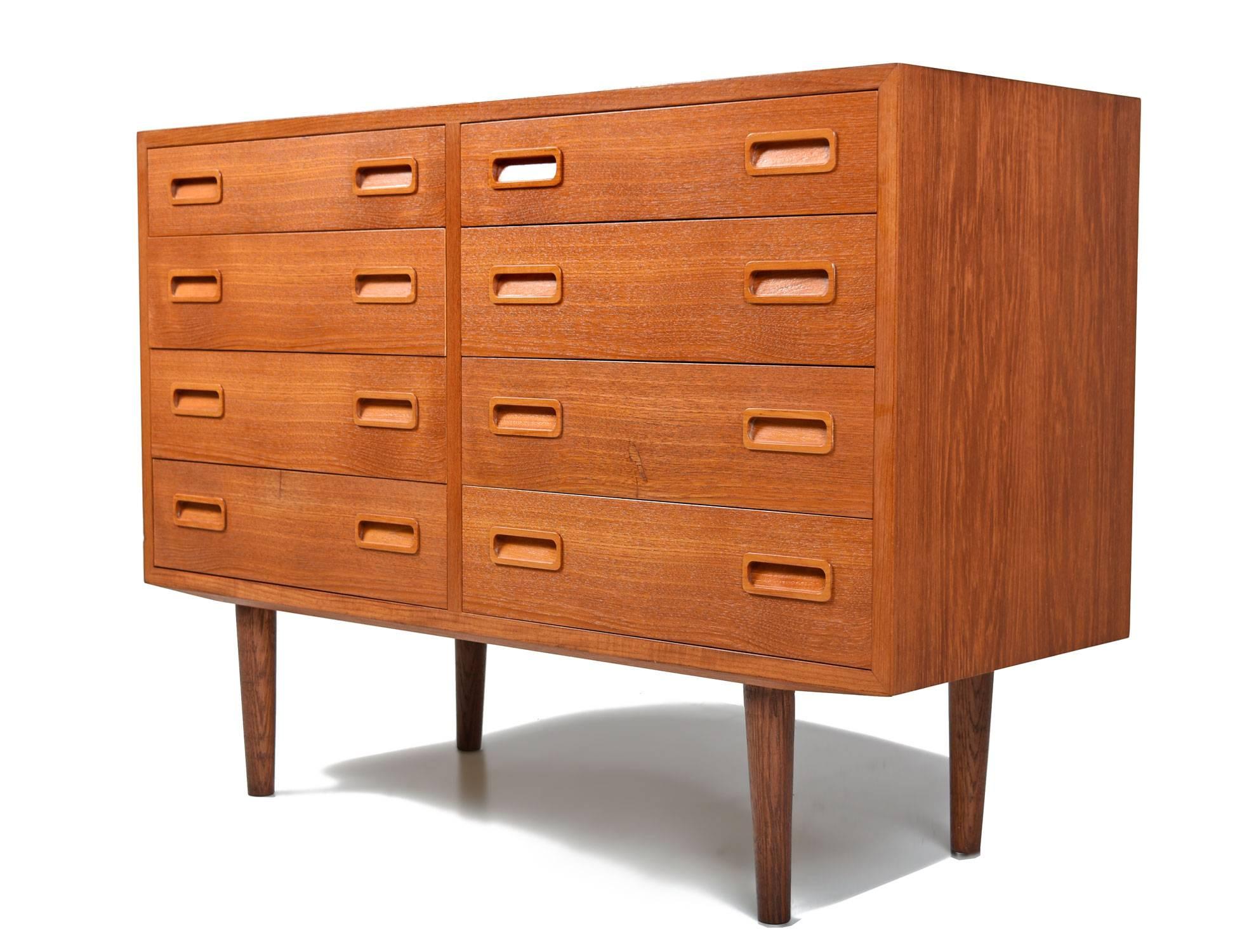 Mid-Century Modern Danish teak dresser by esteemed maker, Poul Hundevad. The unit features eight slim drawers and solid teak recessed handles. The dresser has an uncommon dimension. If you are looking for a piece this size, do not hesitate, it will