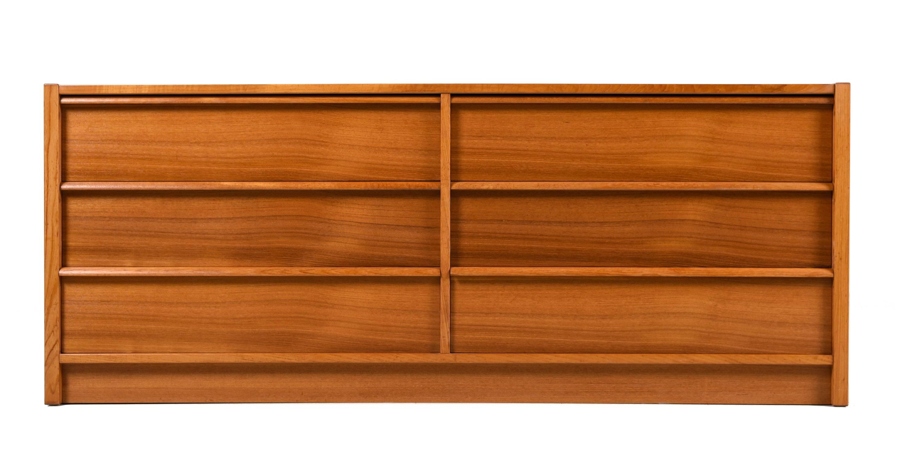 Jesper vintage Danish teak double dresser. Orange patina to the decades old teak wood with an elegant fine grain. Six spacious and deep drawers provide ample storage for your clothing. Expertly crafted in the Scandinavian tradition with tight