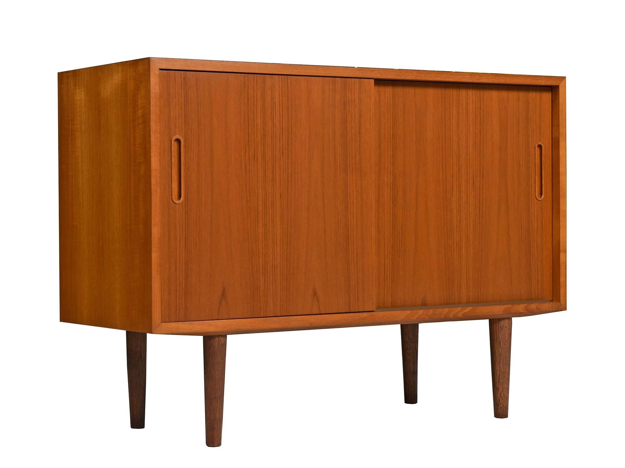 Two Mid-Century Modern Danish teak credenzas by Poul Hundevad. Both credenzas have the same configuration with cabinet space, adjustable shelves and a single felt-lined drawer at top left. Stamped with the maker's mark and Danish Control stamp.