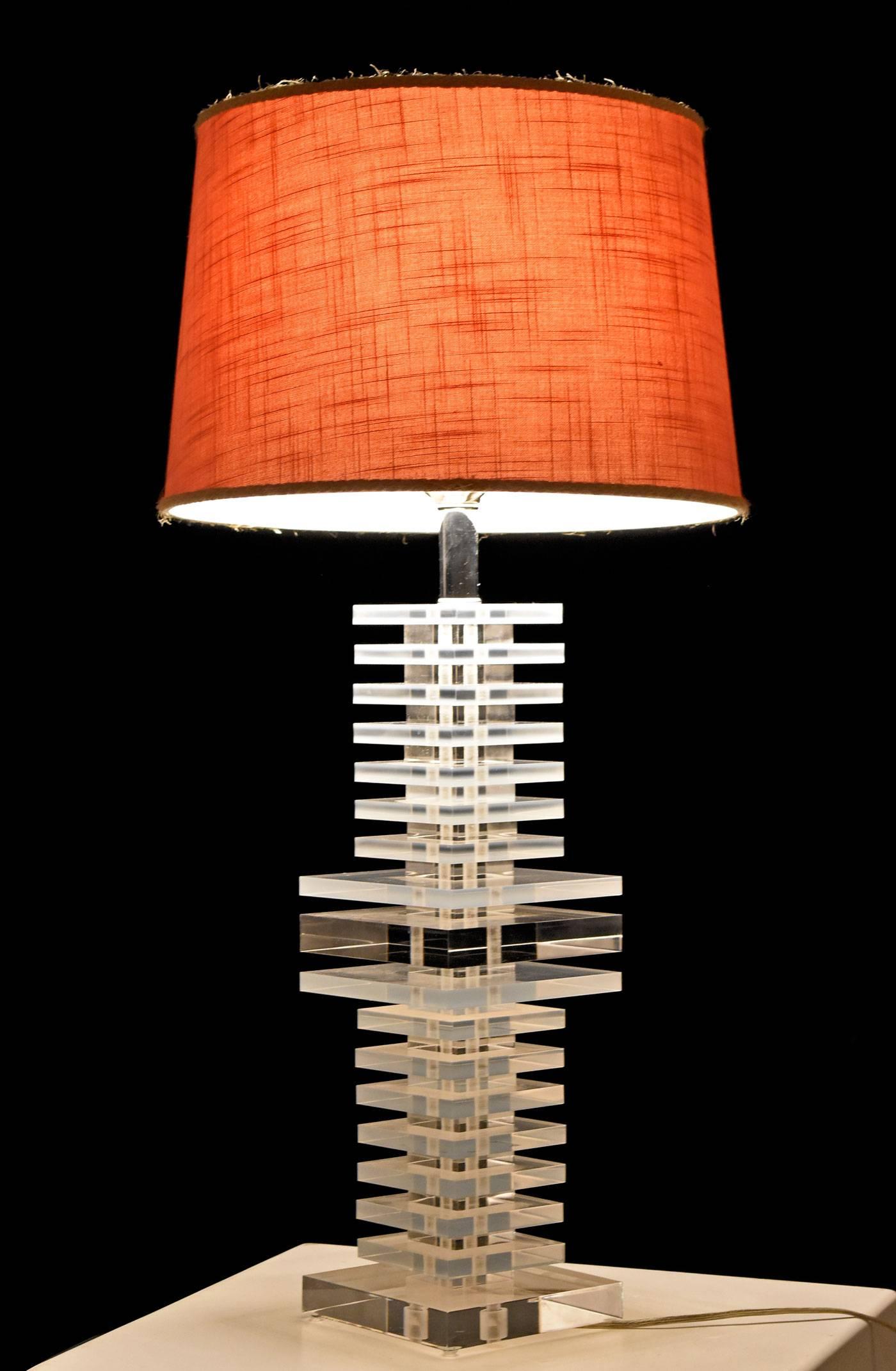 Beautiful Hollywood Regency style Mid-Century Modern Lucite acrylic lamp. Composed of stacked Lucite vertebrae squares on a chrome column spine. Signed by Marlee. Original chrome hardware and pink lamp shade. Works perfectly. The acrylic, chrome and
