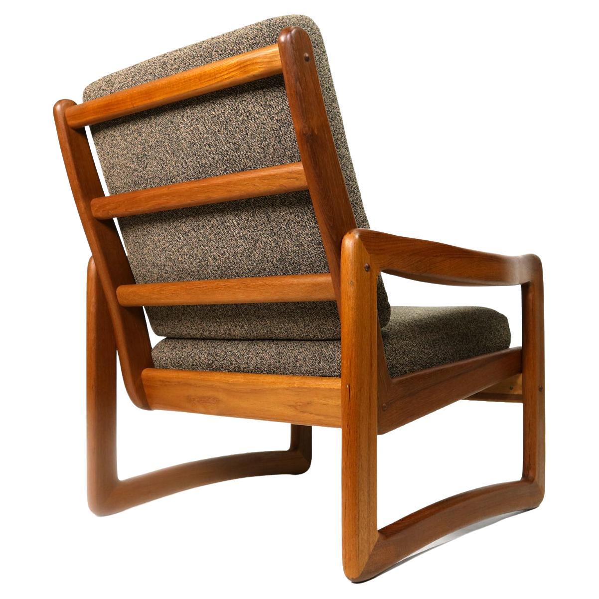 Exceptional vintage solid teak armchair by Sun Cabinet. The Danish modern design features an elegantly contoured U-shaped leg that joins seamlessly with the arms. The ladder rung backside is particularly striking, elevating this lounge chair amongst