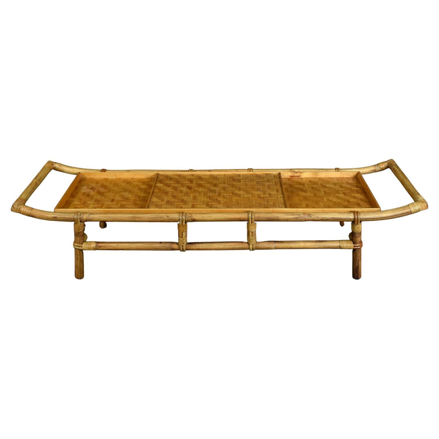 This unique bamboo and rattan pagoda style coffee table was designed by John Wisner for Ficks Reed, circa 1950s. John Wisner graduated from Parsons School Of Design in 1935 and designed for both private clients, and corporate clients including