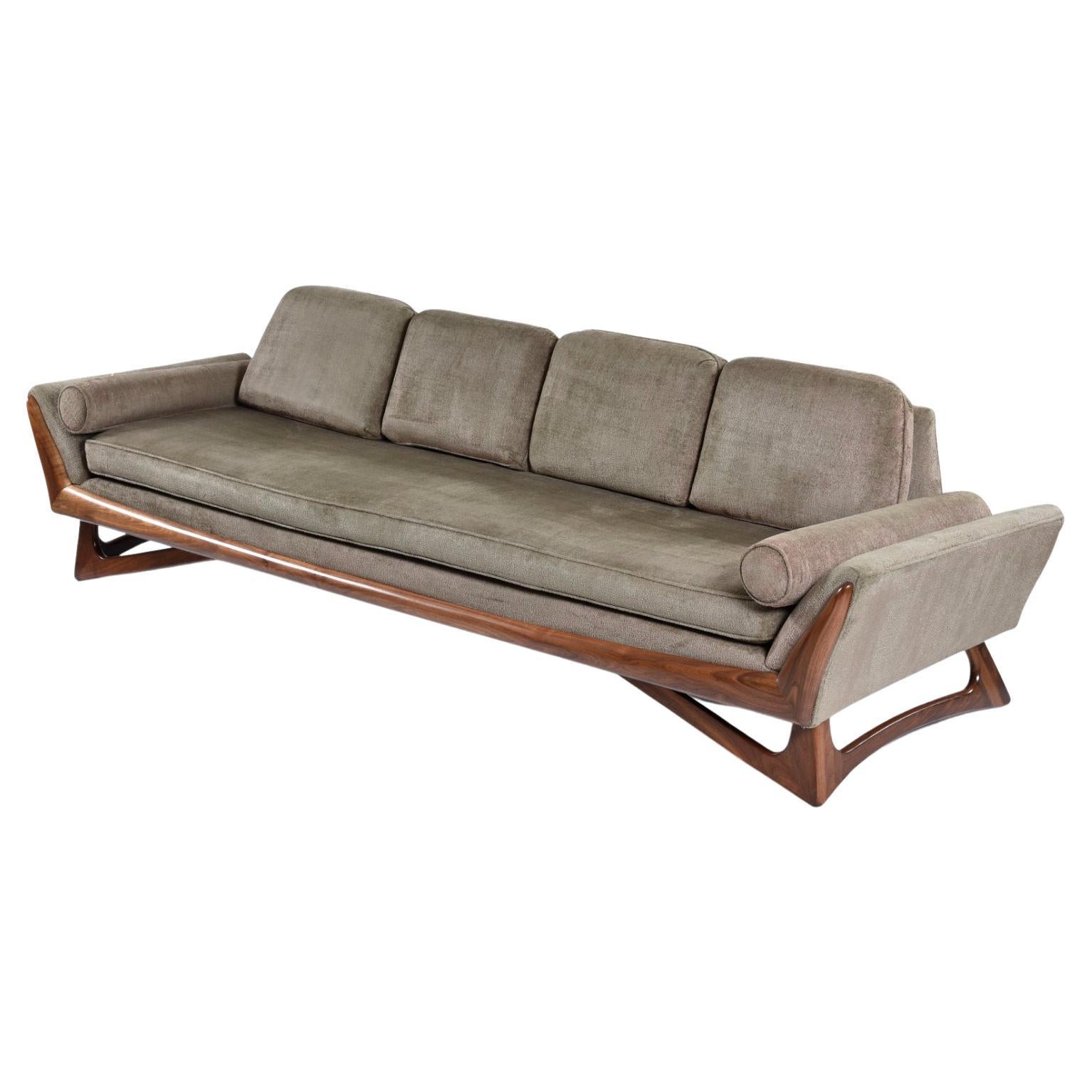 Exceptional four seat Adrian Pearsall style Mid-Century Modern sofa. This gorgeous walnut wood trim couch with triangular legs looks to be the work of Adrian Pearsall. There is no label, so we cannot be certain this piece was created by Pearsall.