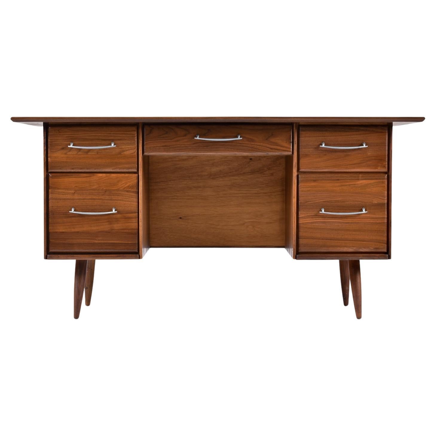 Extraordinary Mid-Century Modern walnut desk with ample storage. Achieve ultimate and storage, function and style with this relatively compact desk. Place this desk anywhere! It’s finished on both the front and back sides. There are five drawers,