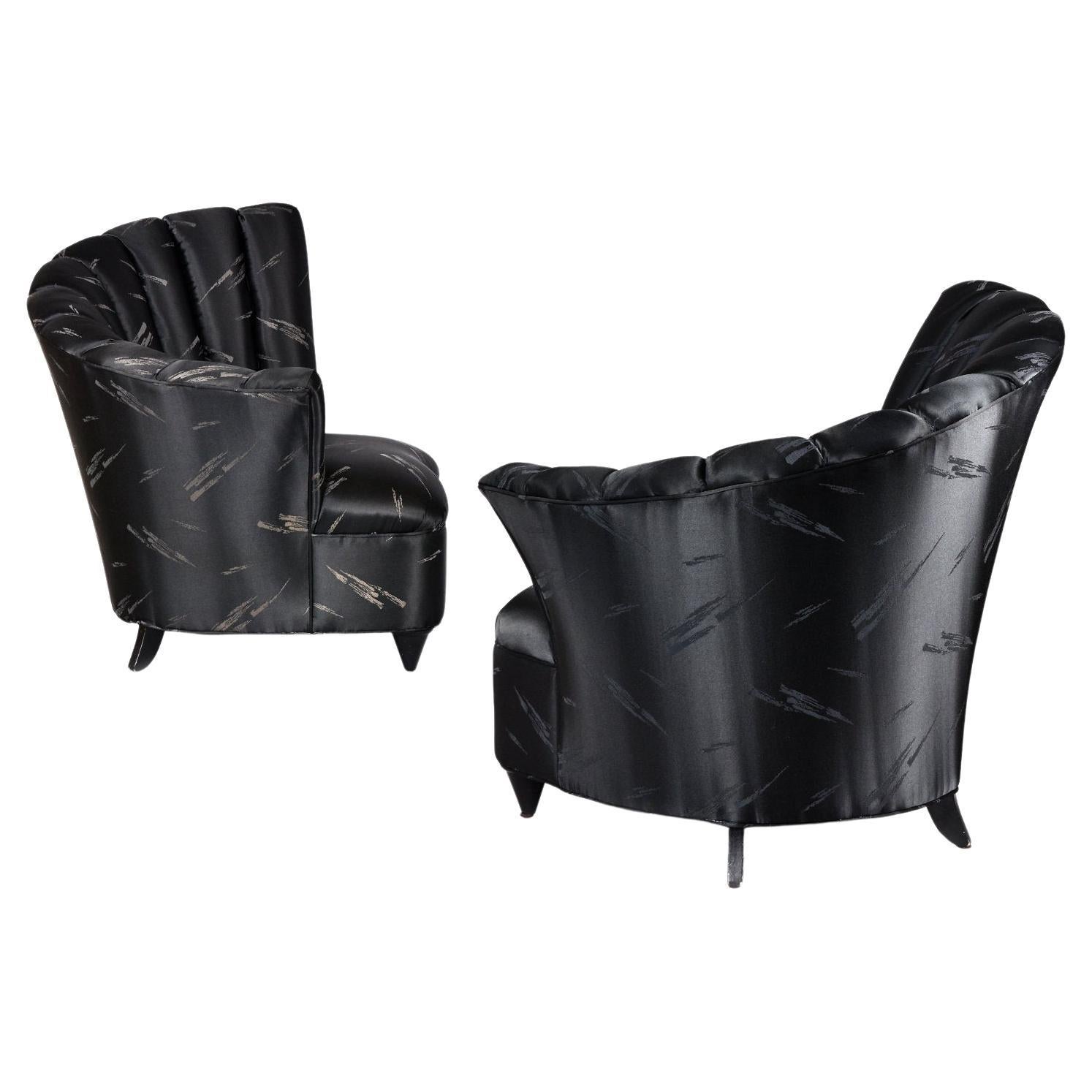 Pair of vintge 1980s Post-Modern / Neo-Deco style black slipper chairs. These chairs fully embody the glamour of the Nineteen-Laties (latter part of the 20th Century). The black fabric is satin-like with a lustrous sheen. There is a black on black