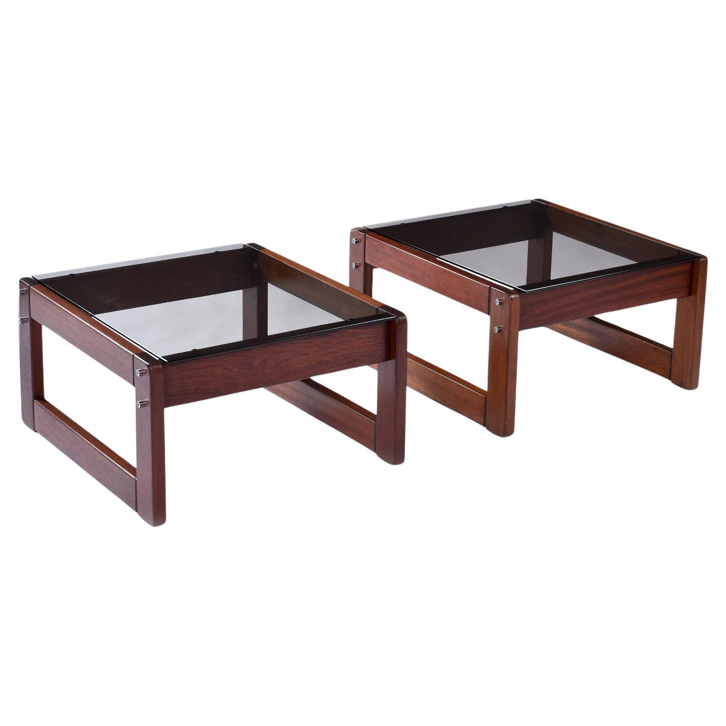 Pair of vintage 1970s Percival Lafer, Brazilian Modern side tables. The deep red hue rosewood bases support a rich smoked glass table top. Both of the tables bear the “Lafer” label. The frames are tastefully complimented by the chrome metal