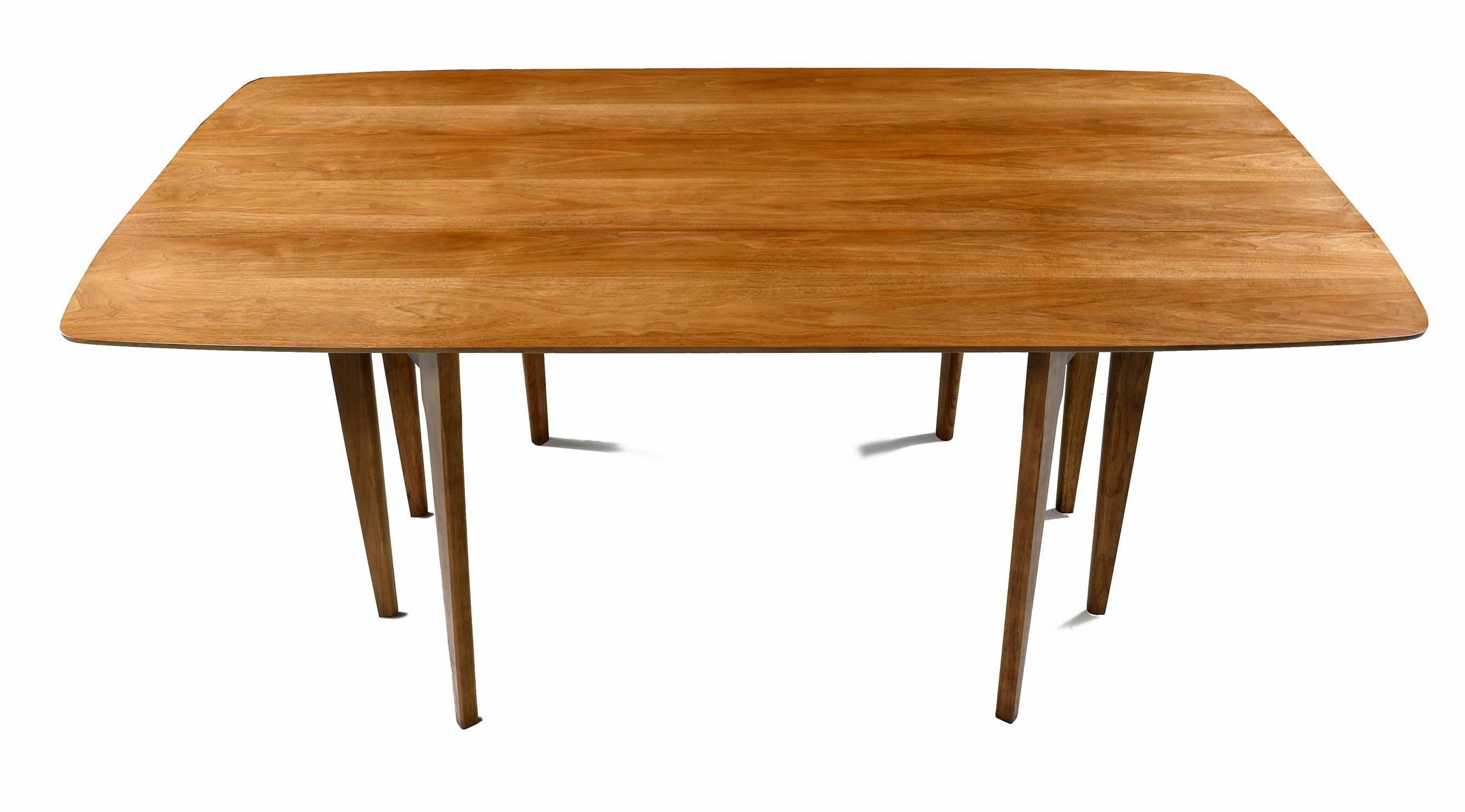 Restored Mid-Century Modern walnut Drexel K43 table, made in the 1960s. This is a multifunctional piece that can serve as a dining table and/or sofa table. Used as a dining table, one can seat six guests. If you are short on space fold down one or