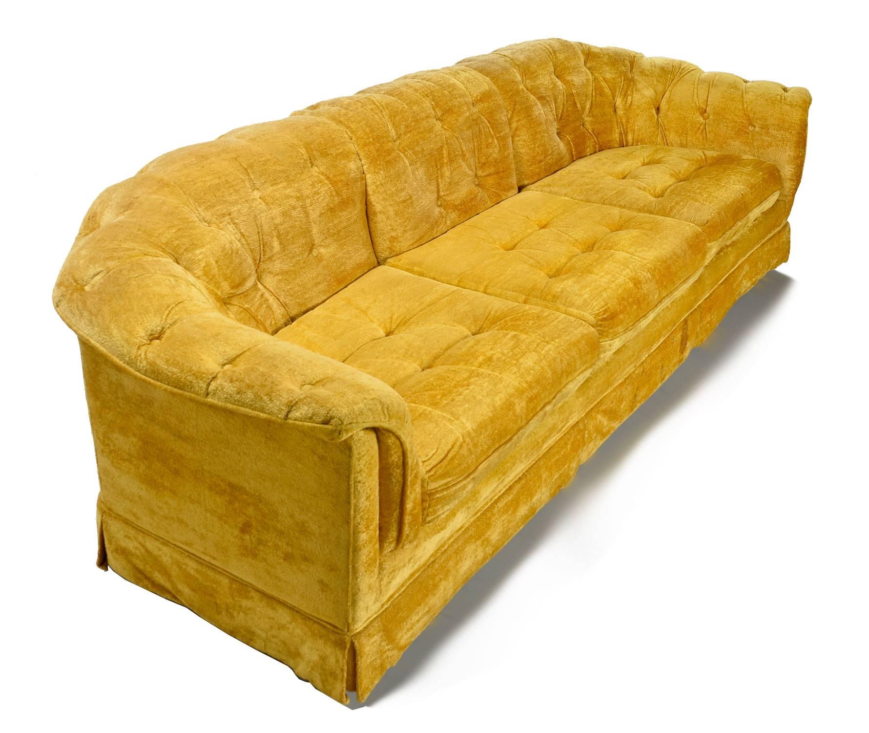 Vintage 1960s large three seat marigold colored velvet tufted sofa. The plush sofa is ultra comfortable! Completely original, in outstanding condition, a true time capsule piece. One does not have to compromise comfort for style with this Hollywood