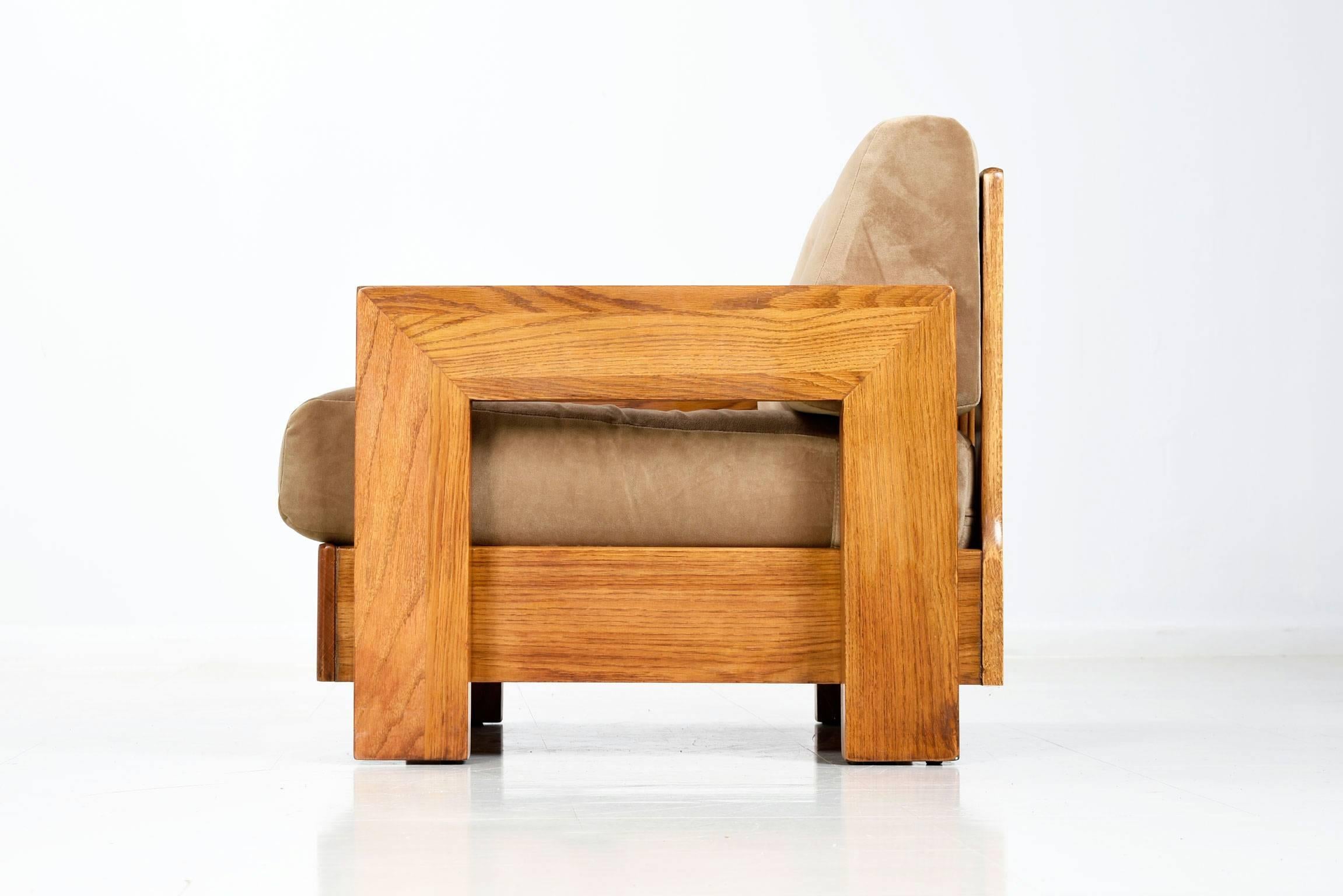Restored solid oak vintage armchair. This Mission style bold, broad and sturdy, the chair blends modernist and traditional elements. The deep seats and thick cushions aid in comfort while providing a high seat height. The chair has been restored