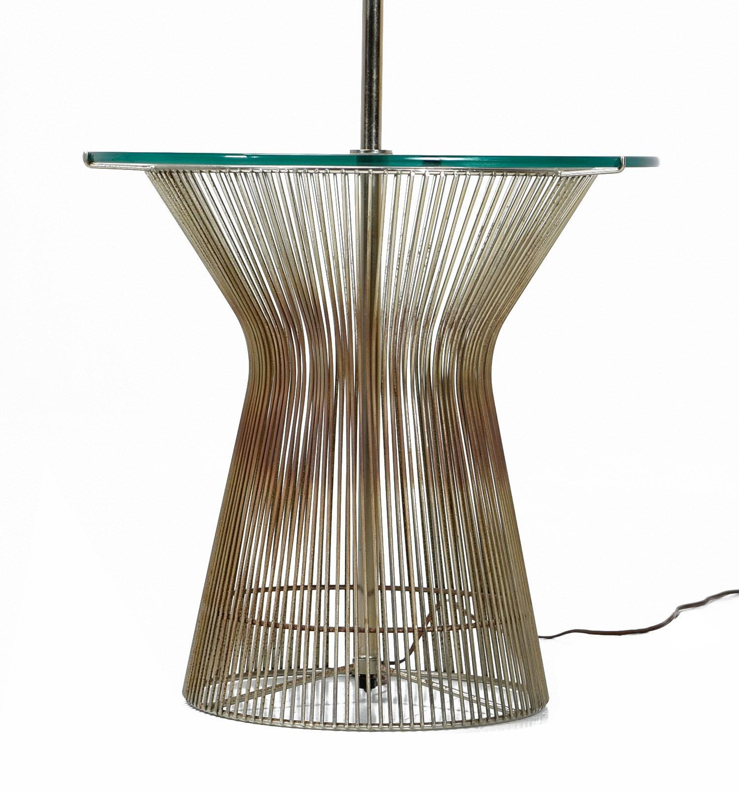 Vintage floor lamp influenced by the famous wire designs by Warren Platner for Knoll. This Mid-Century Modern lamp doubles as a table with the circular glass top. The lamp is outfitted with a contemporary drum lampshade.