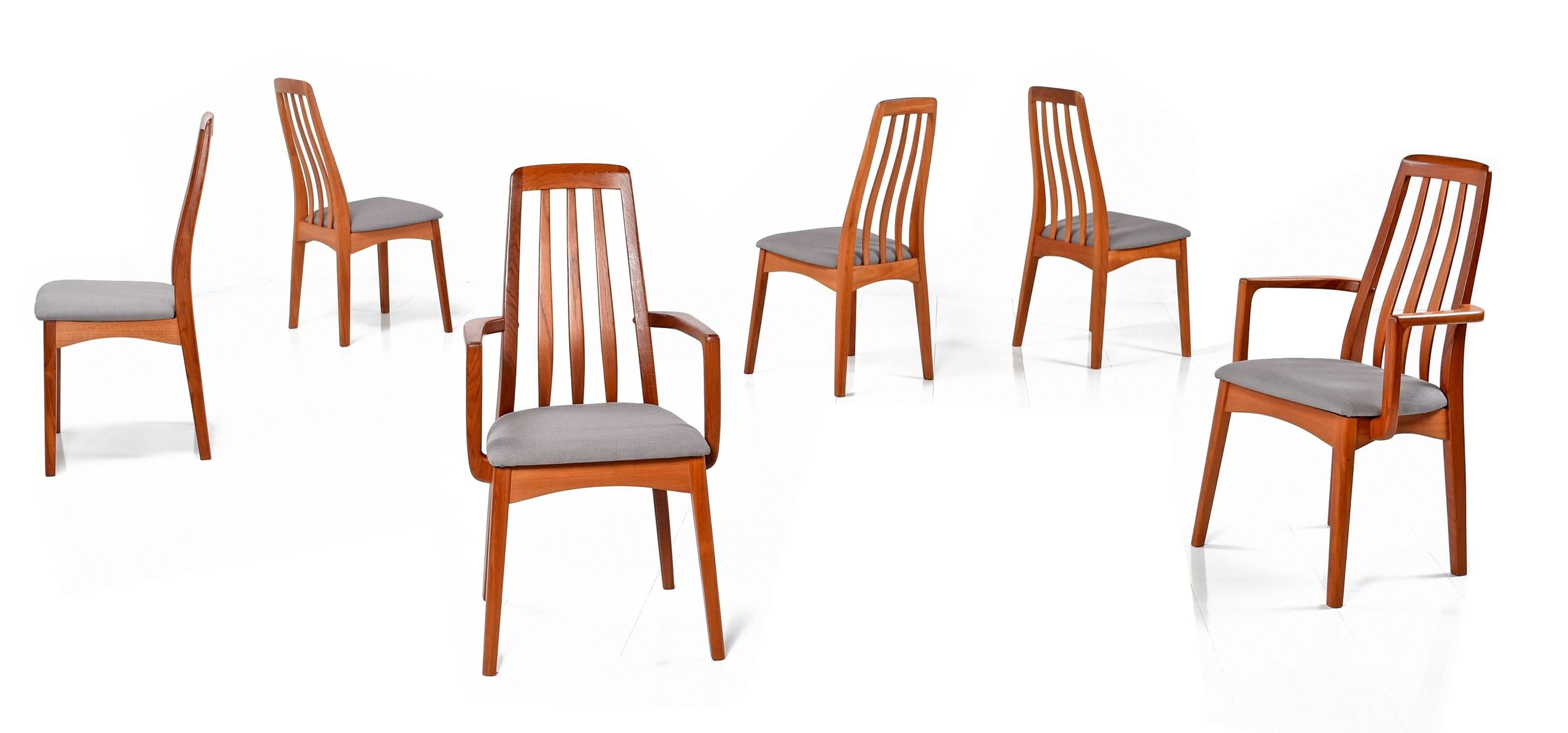 Set of six pre-owned Danish Modern style Benny Linden teak dining chairs with new grey upholstery on the seats. The group includes two armchairs and four armless side chairs. The solid teak chairs are made in Thailand and bear the maker's mark.