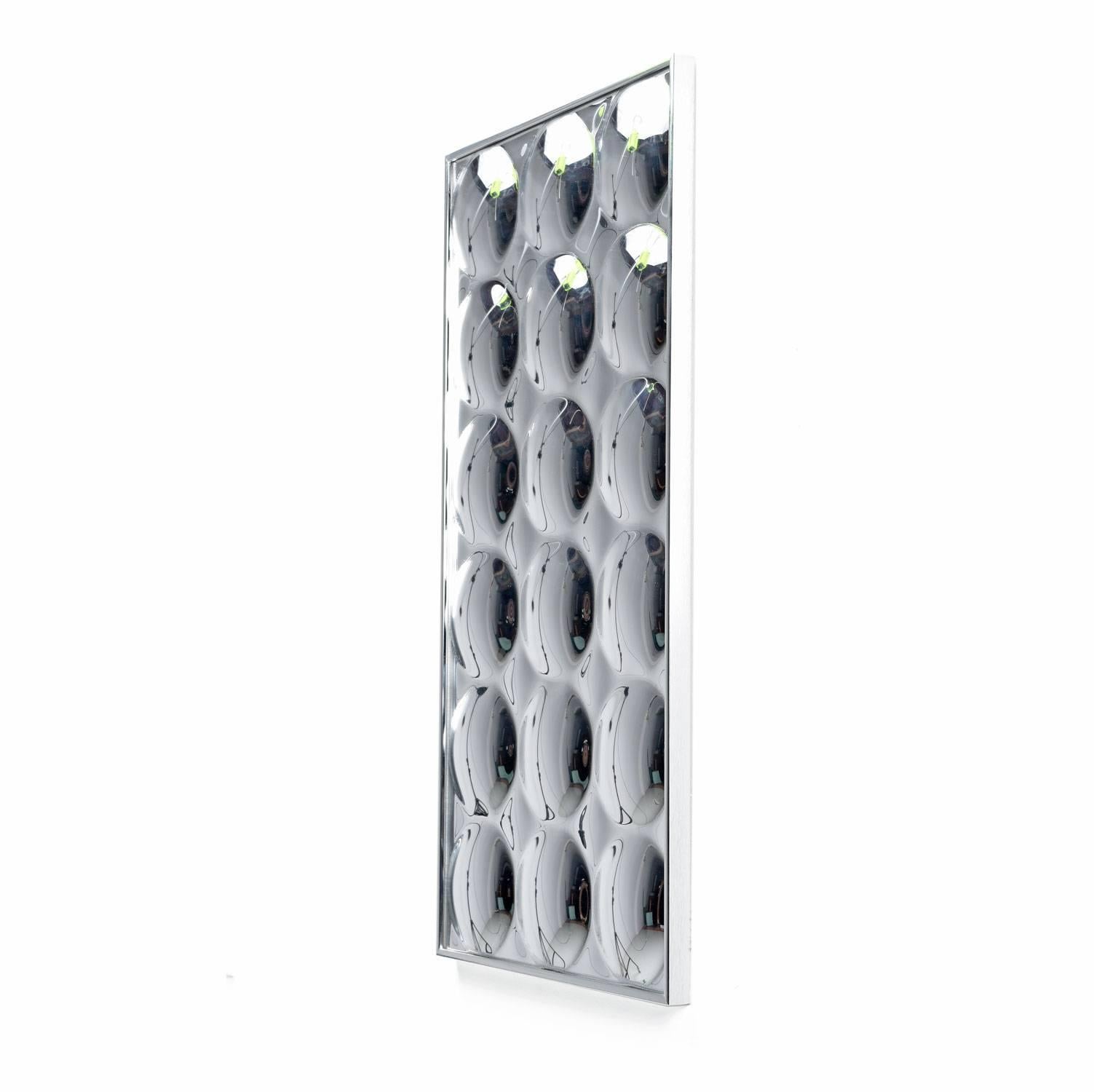 18 silvered acrylic bubbles come together inside a brushed chrome frame to create this optical wall art. Each bubble reflects and refracts everything in its view.
