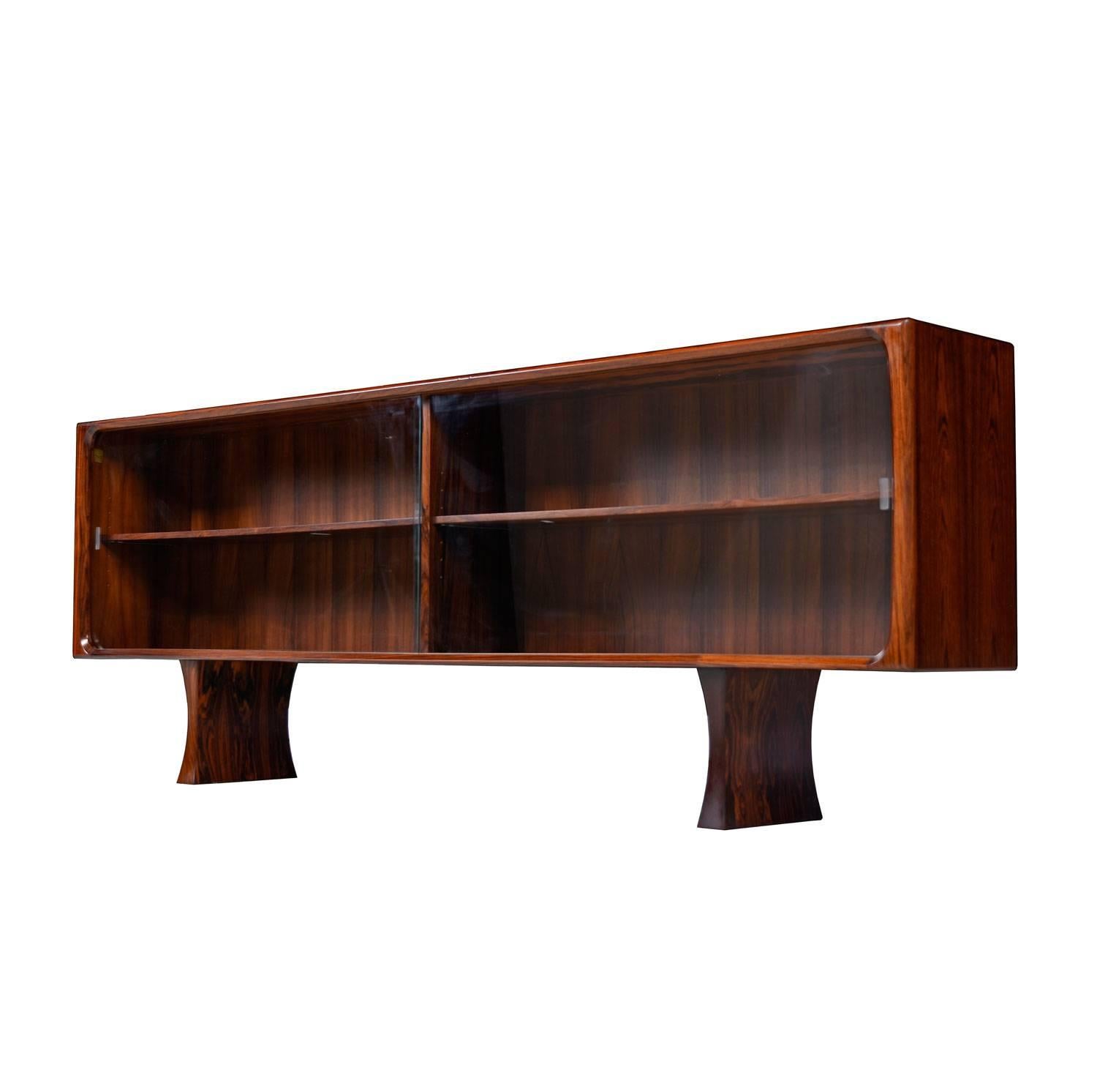 Mid-Century Modern low profile Danish rosewood bookcase by Bernhard Pedersen & Son. Exceptional quality construction. Elegantly contoured solid rosewood banding enhances the perimeters. Two bay design with a single adjustable height shelf on each