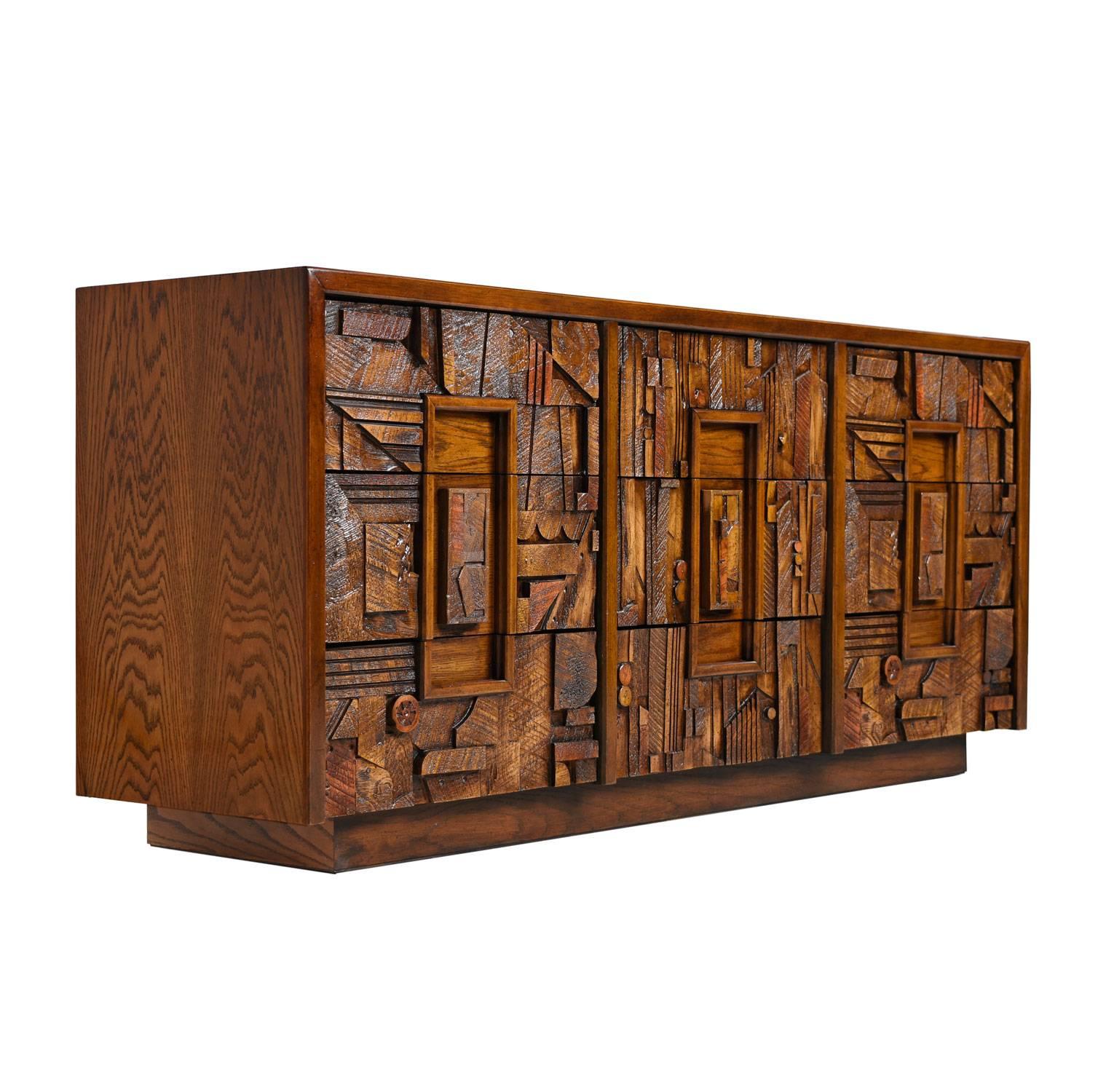 A vintage, 1970s, lane Brutalist triple dresser. A highly textured pattern adorns the front facade. The rough hewn forms exemplify the Brutalist aesthetic. Ample storage with a total of nine spacious drawers. Complete your bedroom set with the