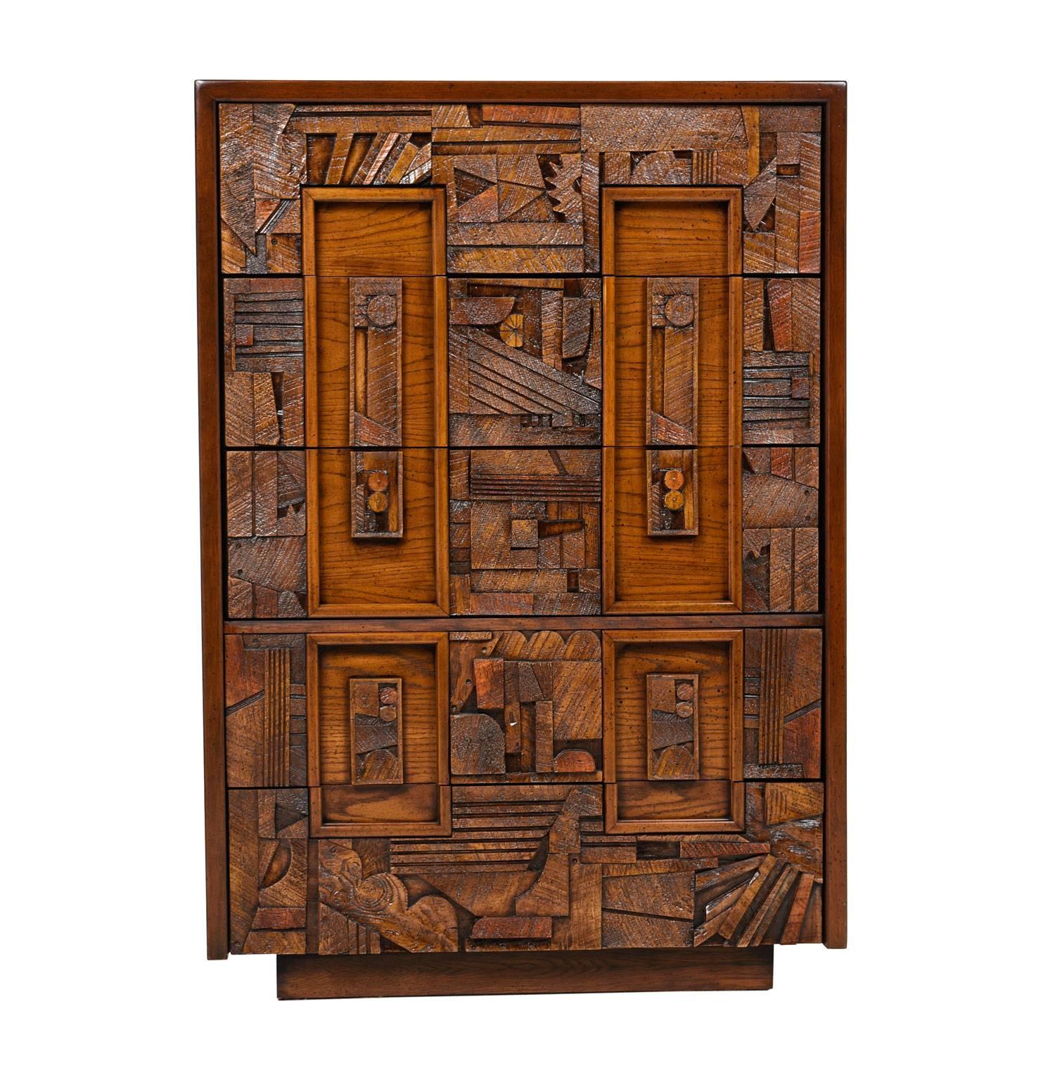 A midcentury, Brutalist dresser inspired by the work of American designer Paul Evans that was produced by Lane. Intricately laid and highly textured patterns adorn the front facade. The roughhewn forms exemplify the Brutalist aesthetic. The bold,