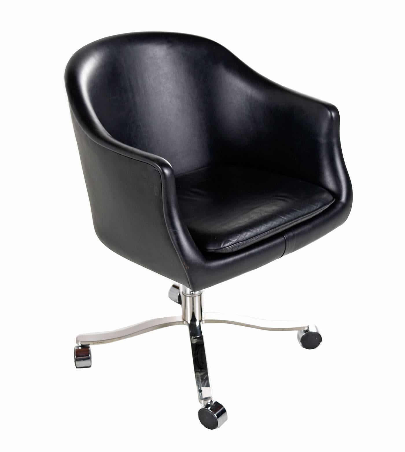 Nicos Zographos black leather bucket chair on casters. Four-star chrome-plated base. Tilt, swivel, adjustable, tilt lock. Maker name is etched in chrome base.

 