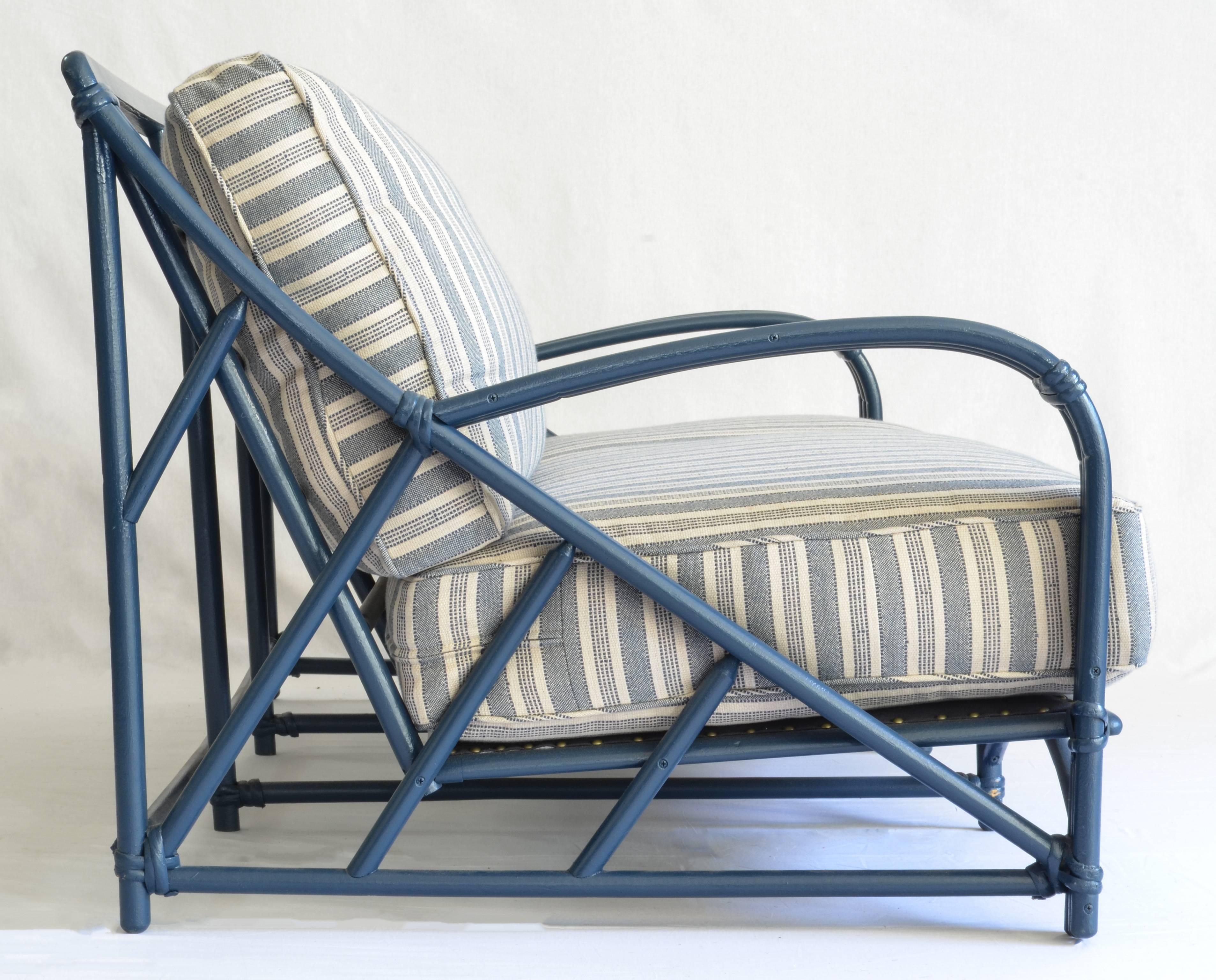 Graphic rattan frame newly painted a deep, marine blue, and freshly upholstered in Peter Dunham textiles performance fabric (Sunbrella yarns) Amida stripe in indigo on natural.