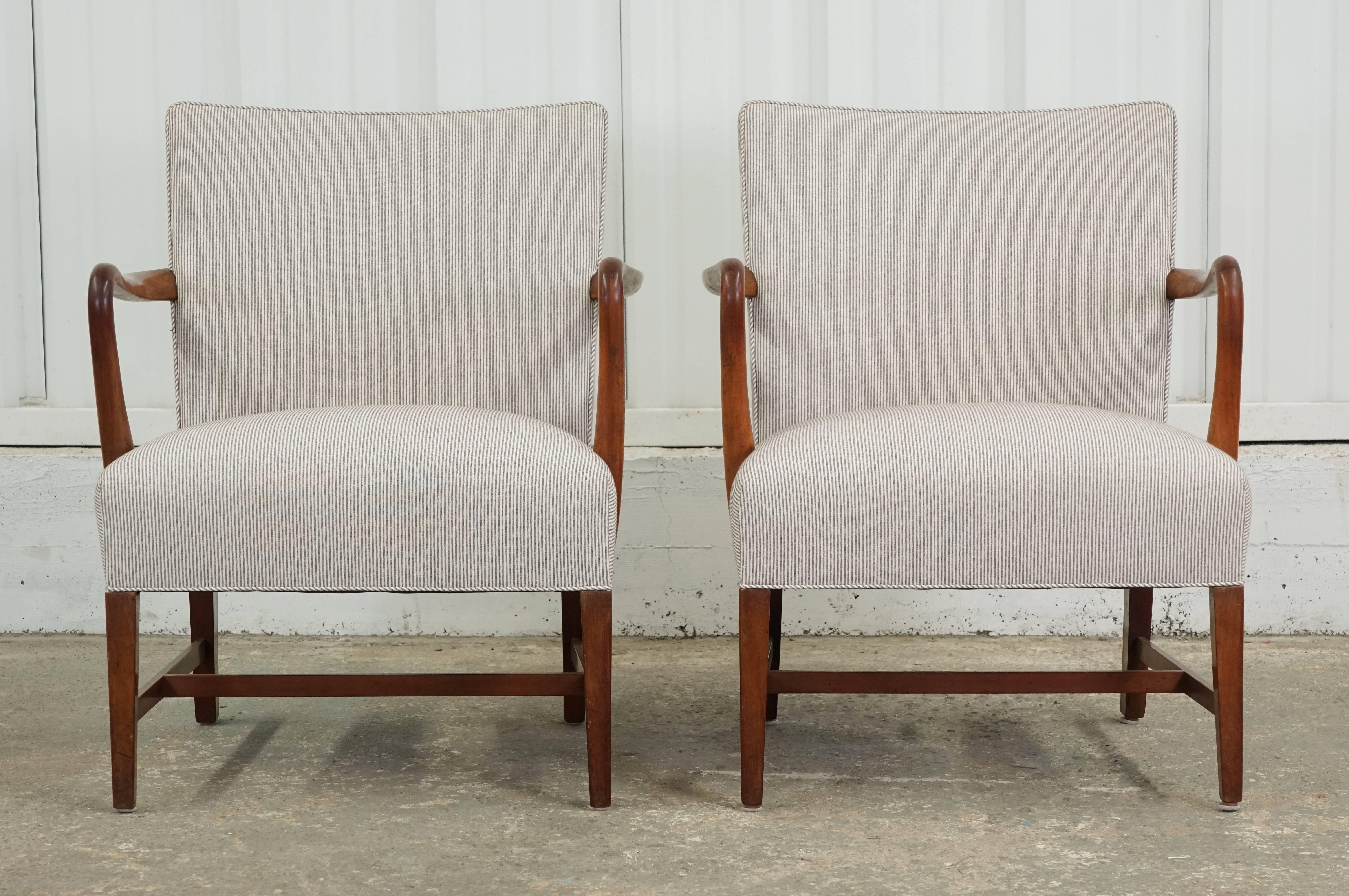 Pair of 1950s Danish armchairs upholstered in a light pinstripe fabric. Unknown designer but similar to Jakob Kjaer designs. 