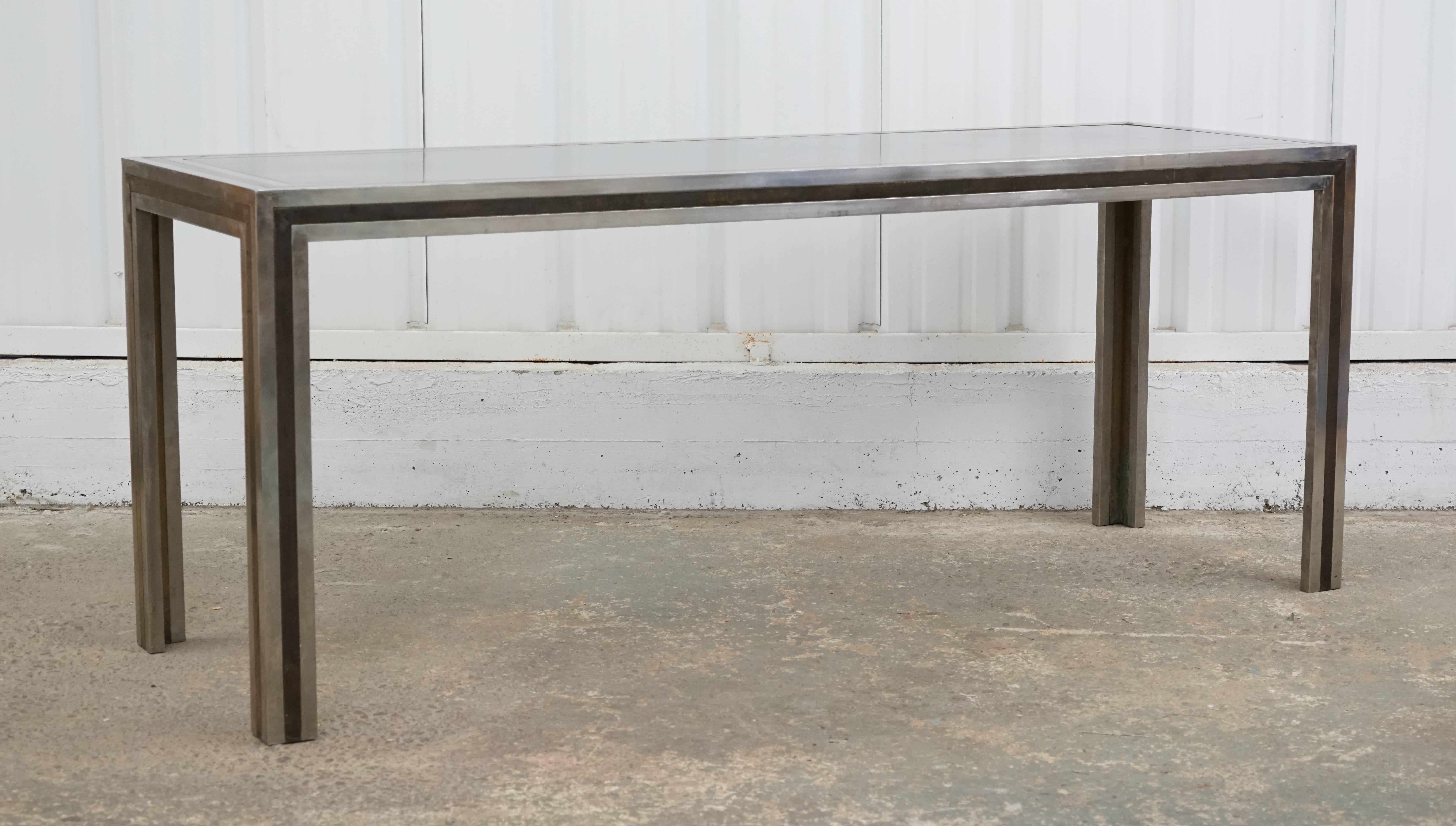 A 1970s brass and steel console table by Romeo Rega. Beautiful age appropriate patina. 
