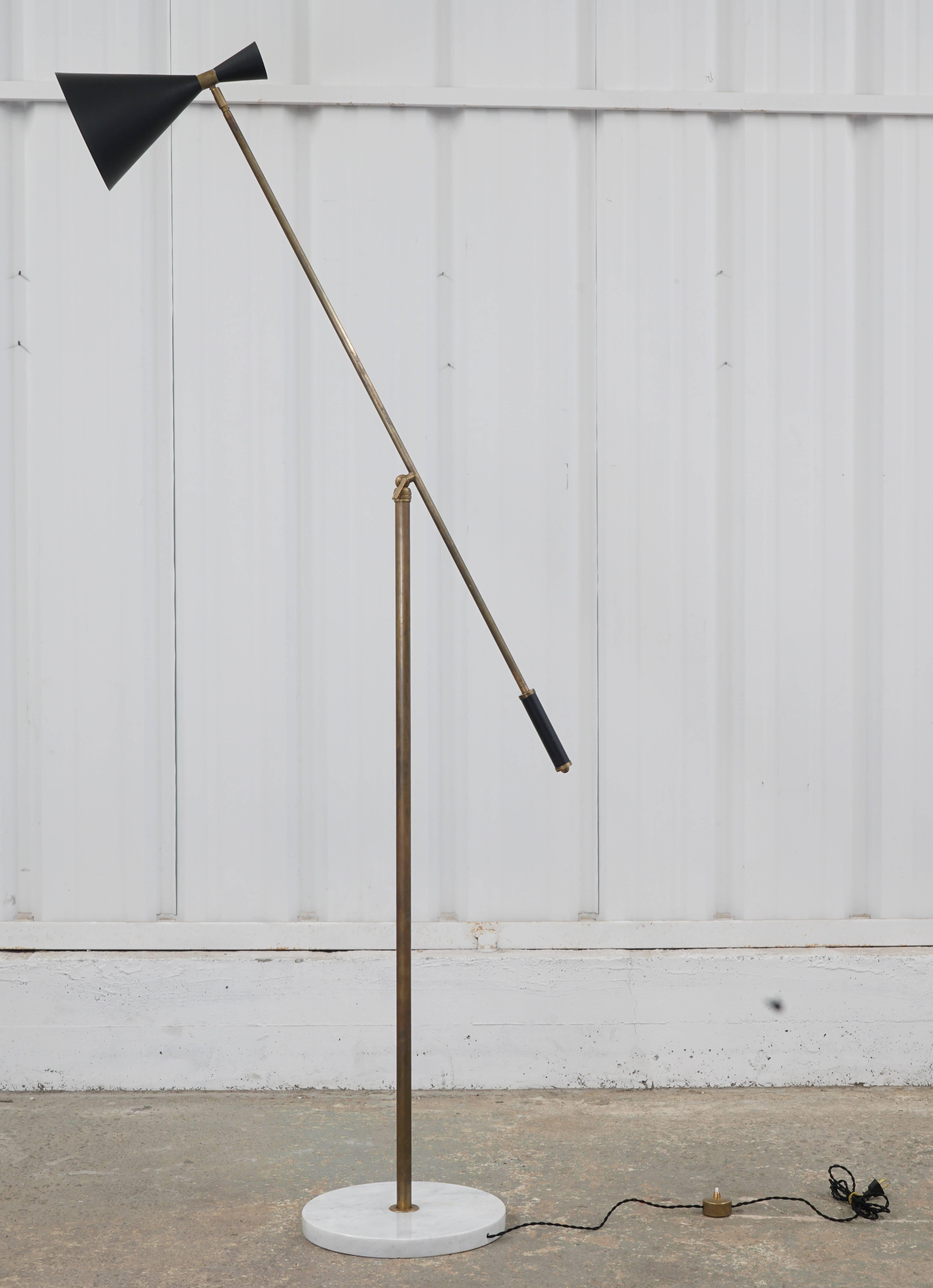 1960s Italian articulating floor lamp with a marble base, brass body, and metal shade. Shade and arm adjust. Newly rewired with black silk-wrapped cord, and original metal floor pedal for on/off switch.