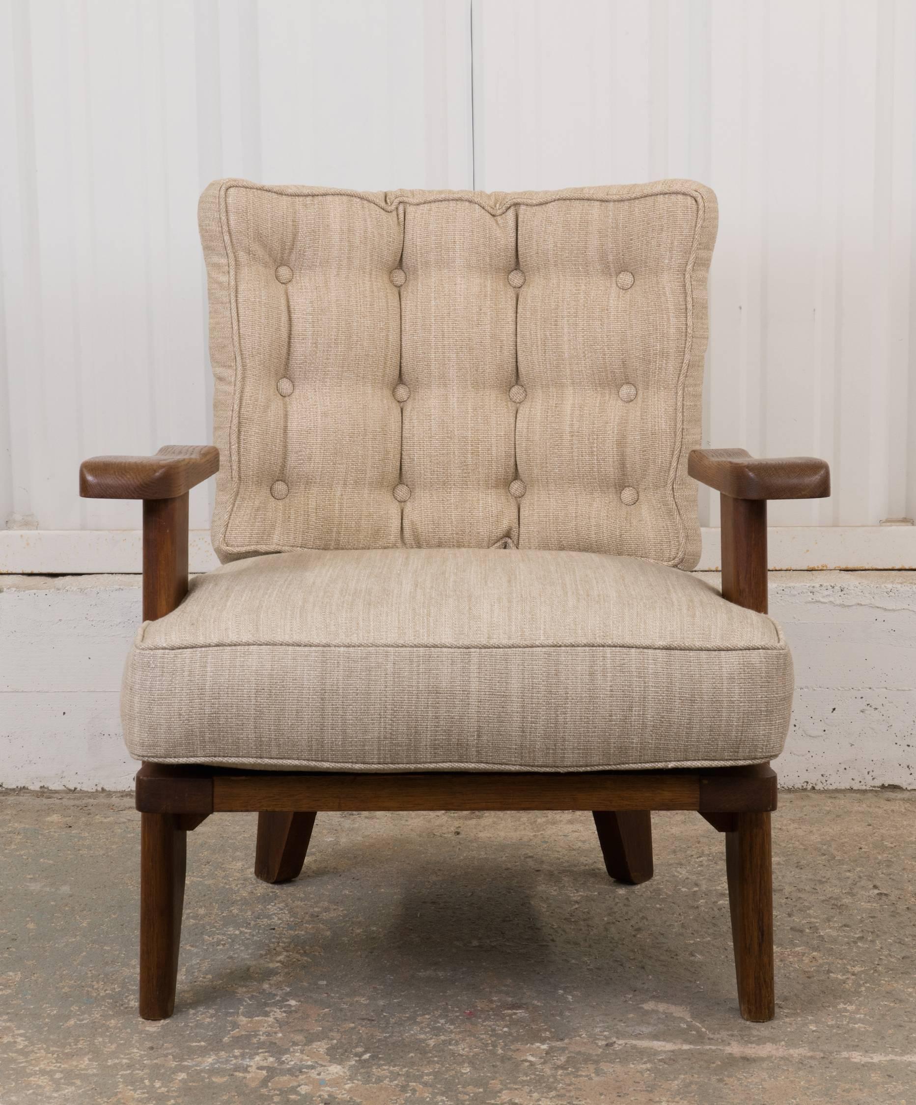 Small, single Guillerme et Chambron oak armchair, newly upholstered in a neutral fabric. One of the fun features of this chair is a hidden cup holder that swivels out when needed.