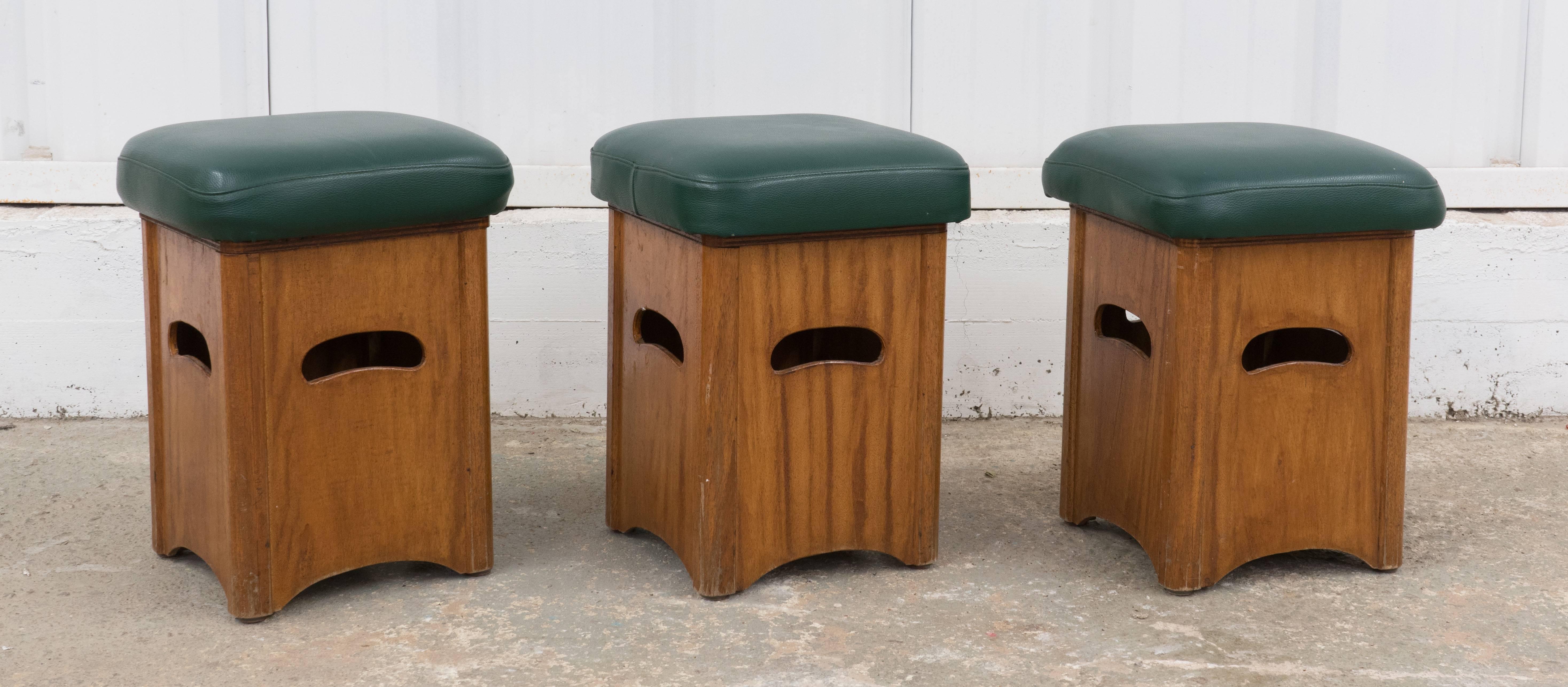 Set of three yacht stools with original green vinyl upholstery.