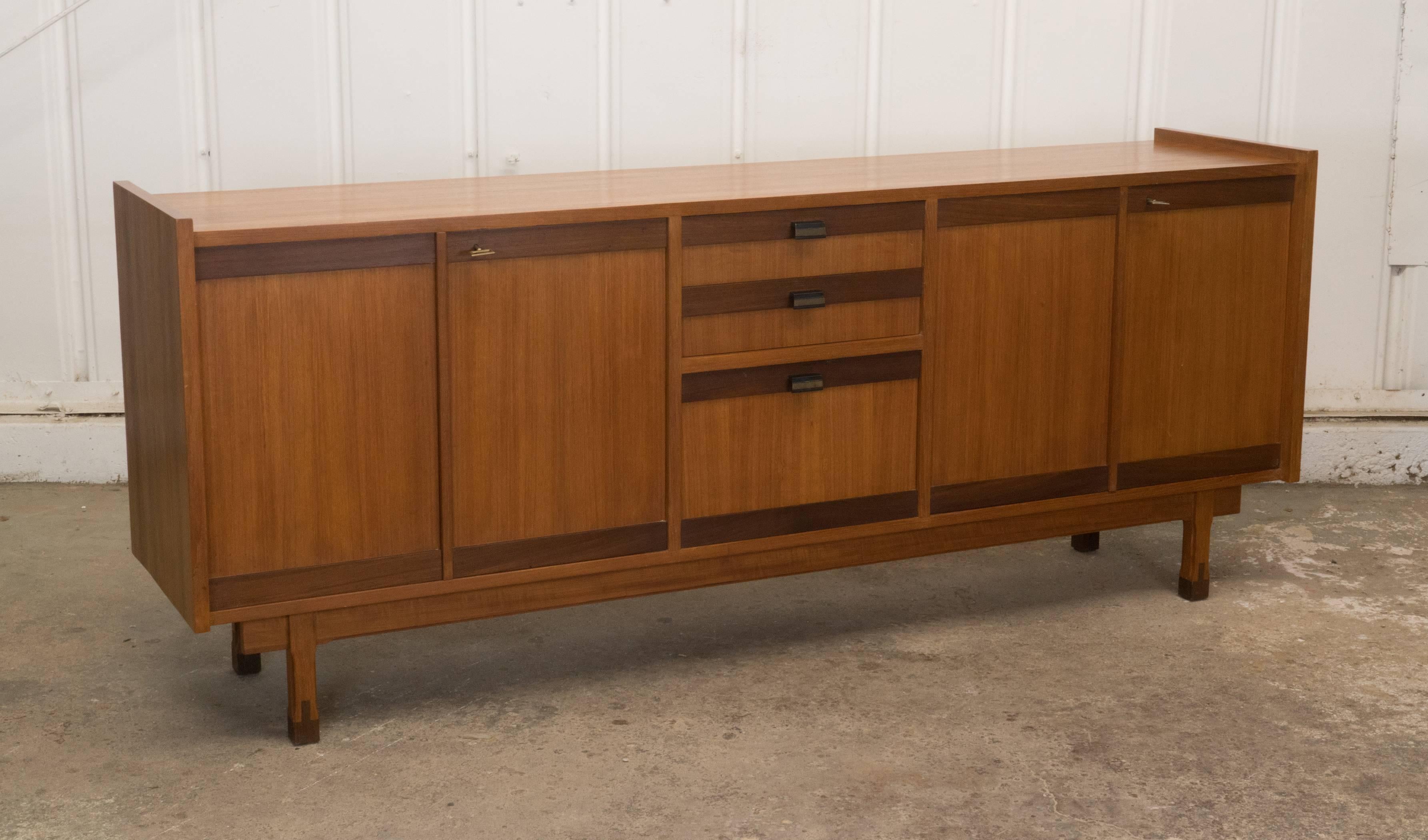 Vintage Danish teak credenza with functioning and chic key detail, interior shelves, and drop-down centre console.