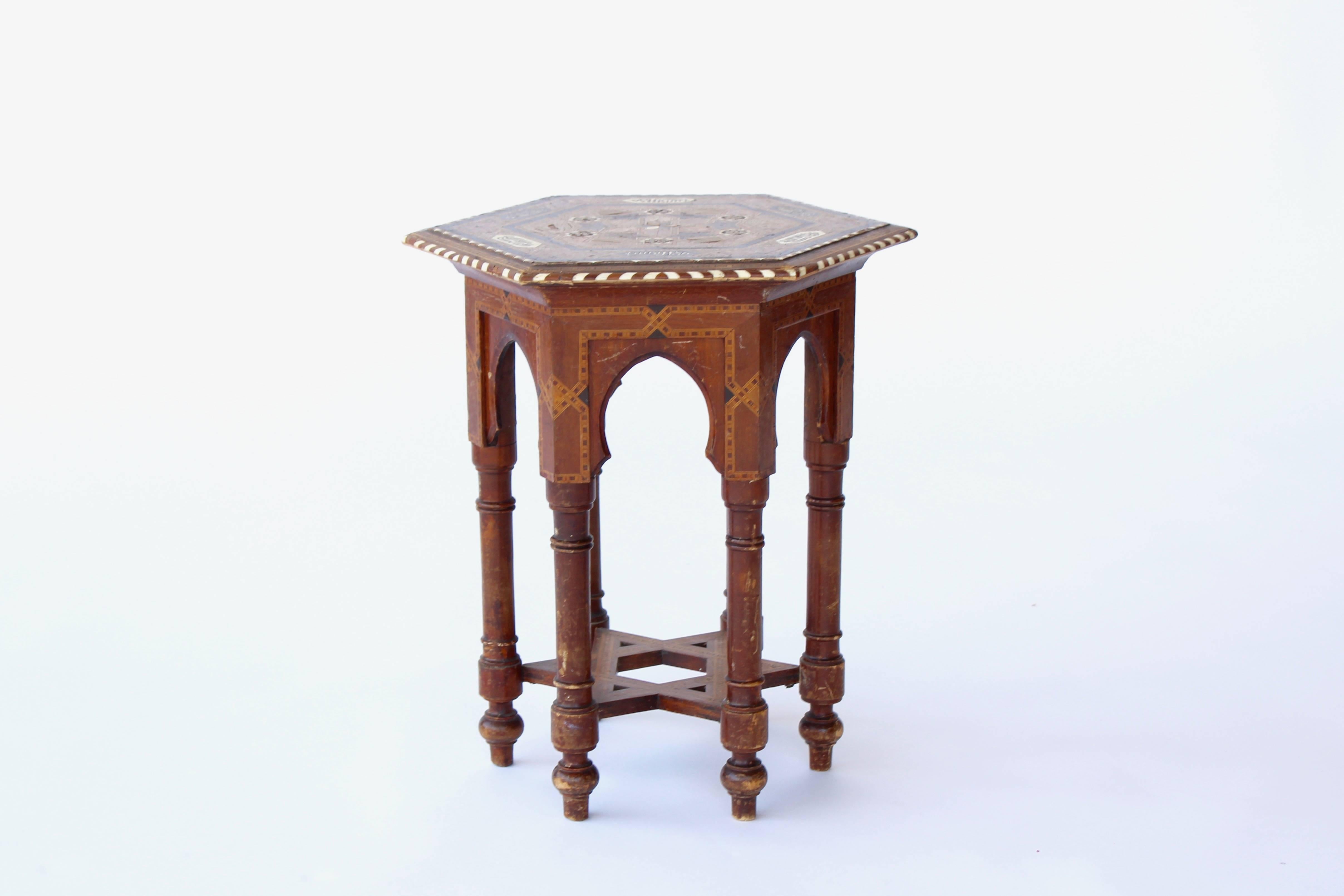 Antique Mid-Eastern table, likely from Egypt, with beautiful inlay details of various wood species and bone. Base creates a star motif, and legs have some distressing/age.