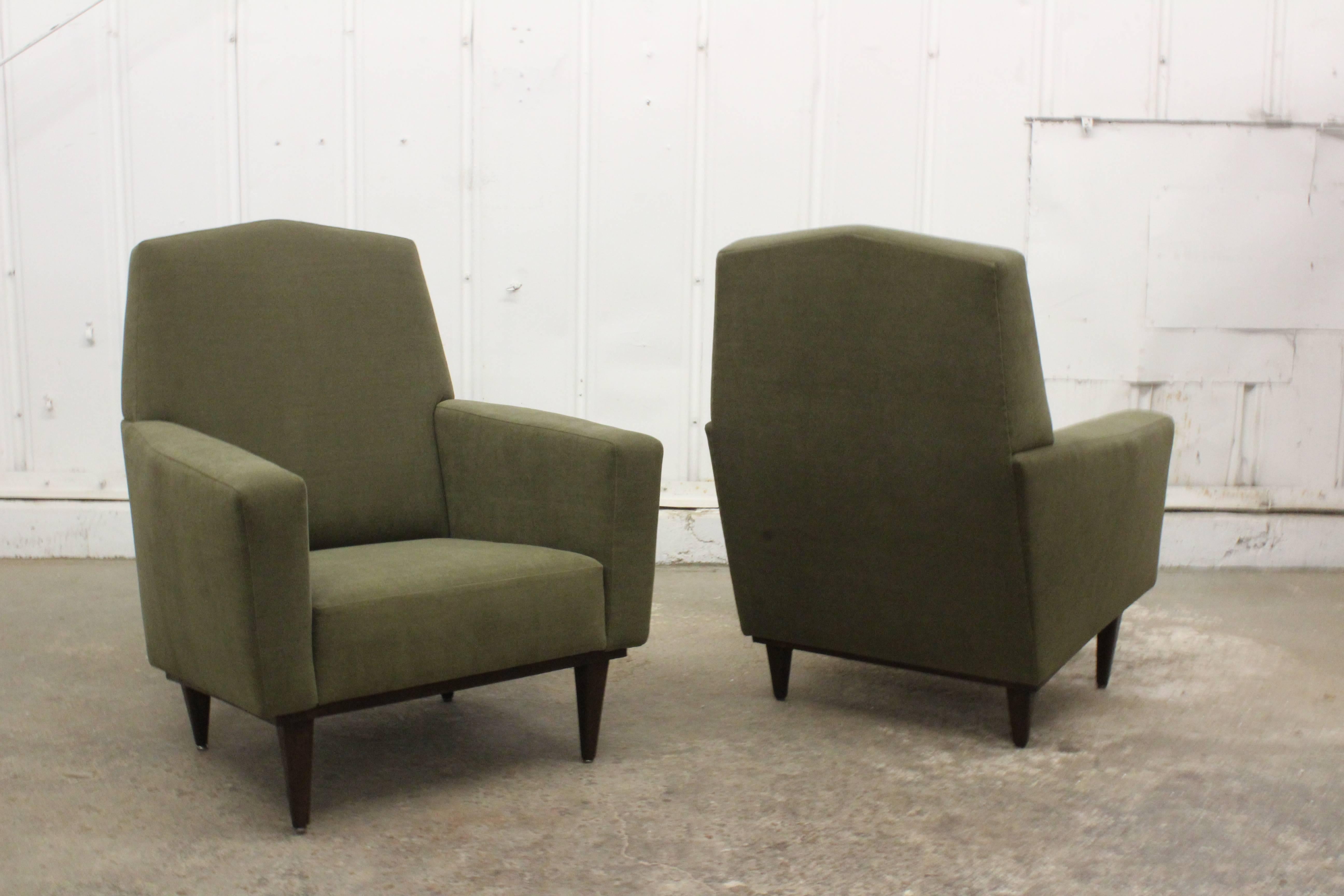 Pair of 1950s French armchairs with modern lines and walnut legs. The pair feature a soft new olive green chenille upholstery.